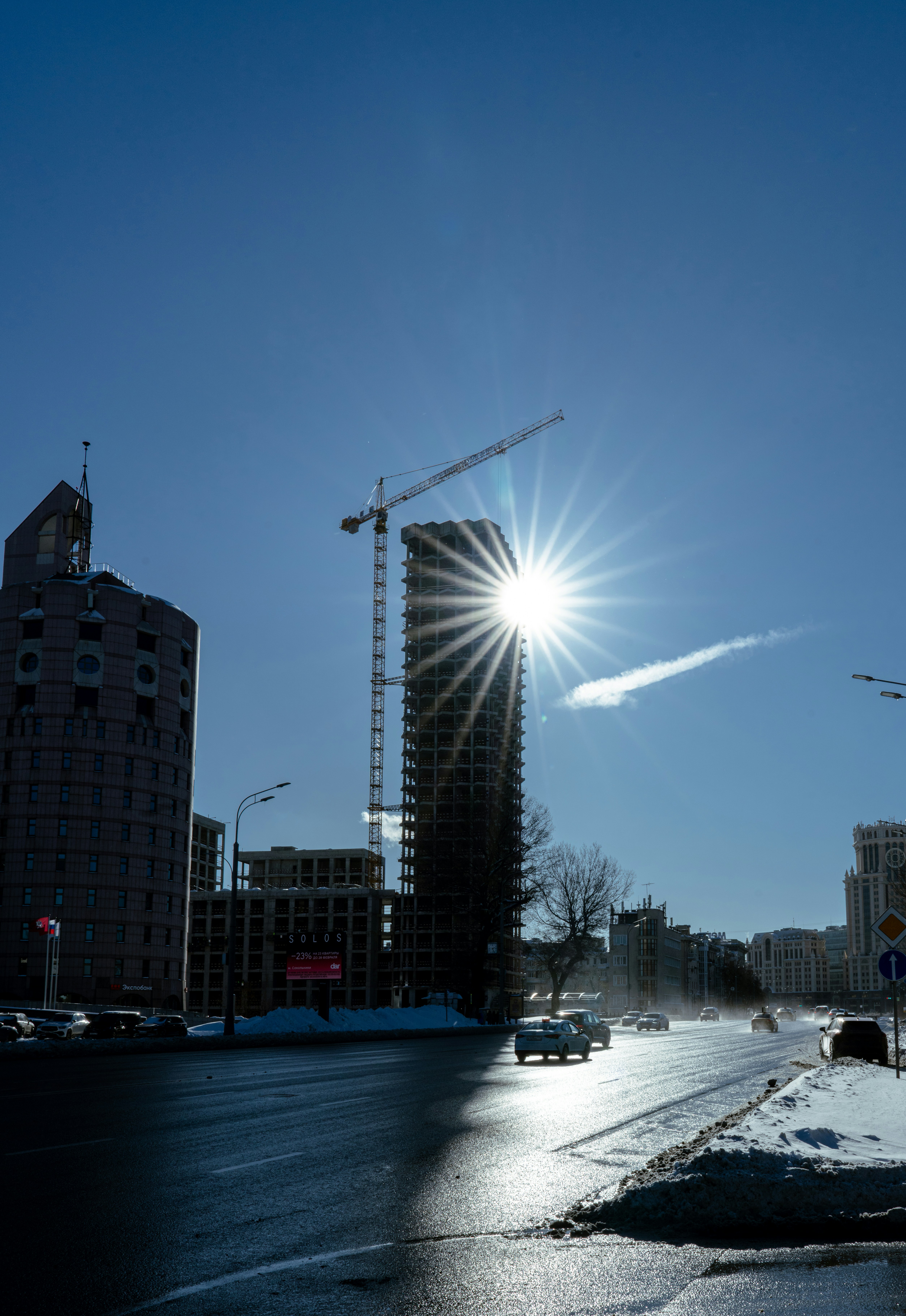 Sunburst over a city street with construction