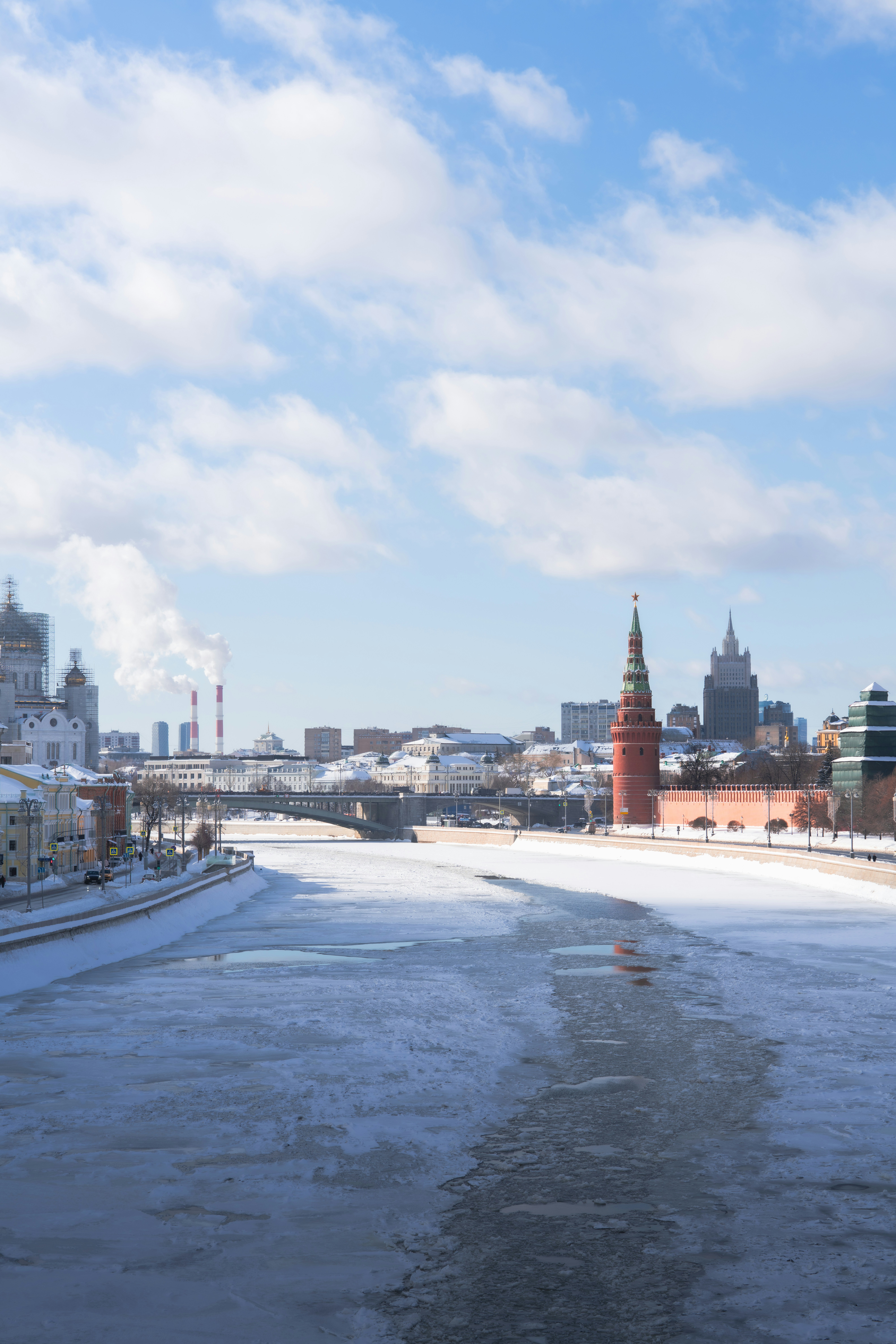 Frozen river with cityscape and kremlin towers in winter.