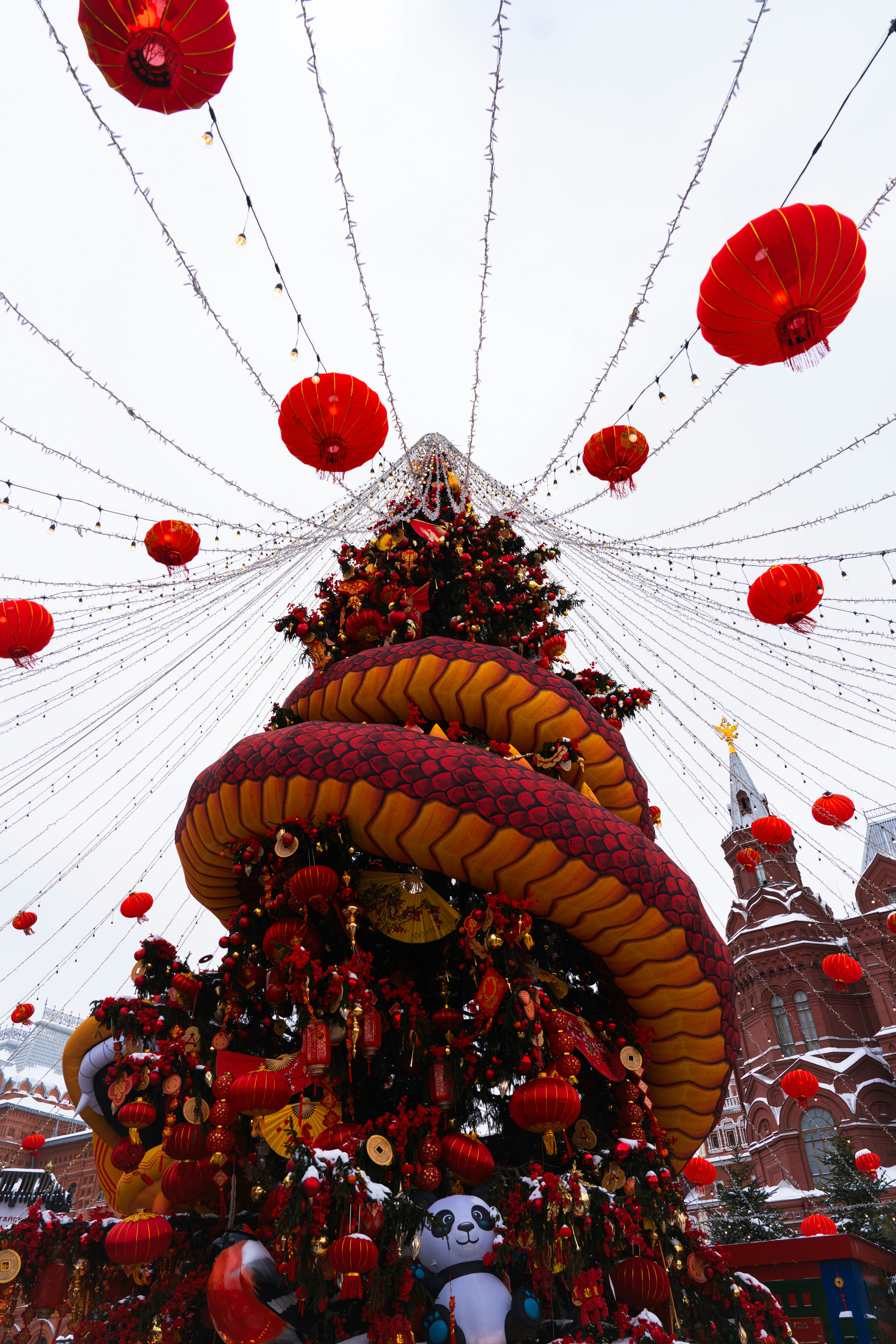 Dragon decoration on a christmas tree with lanterns