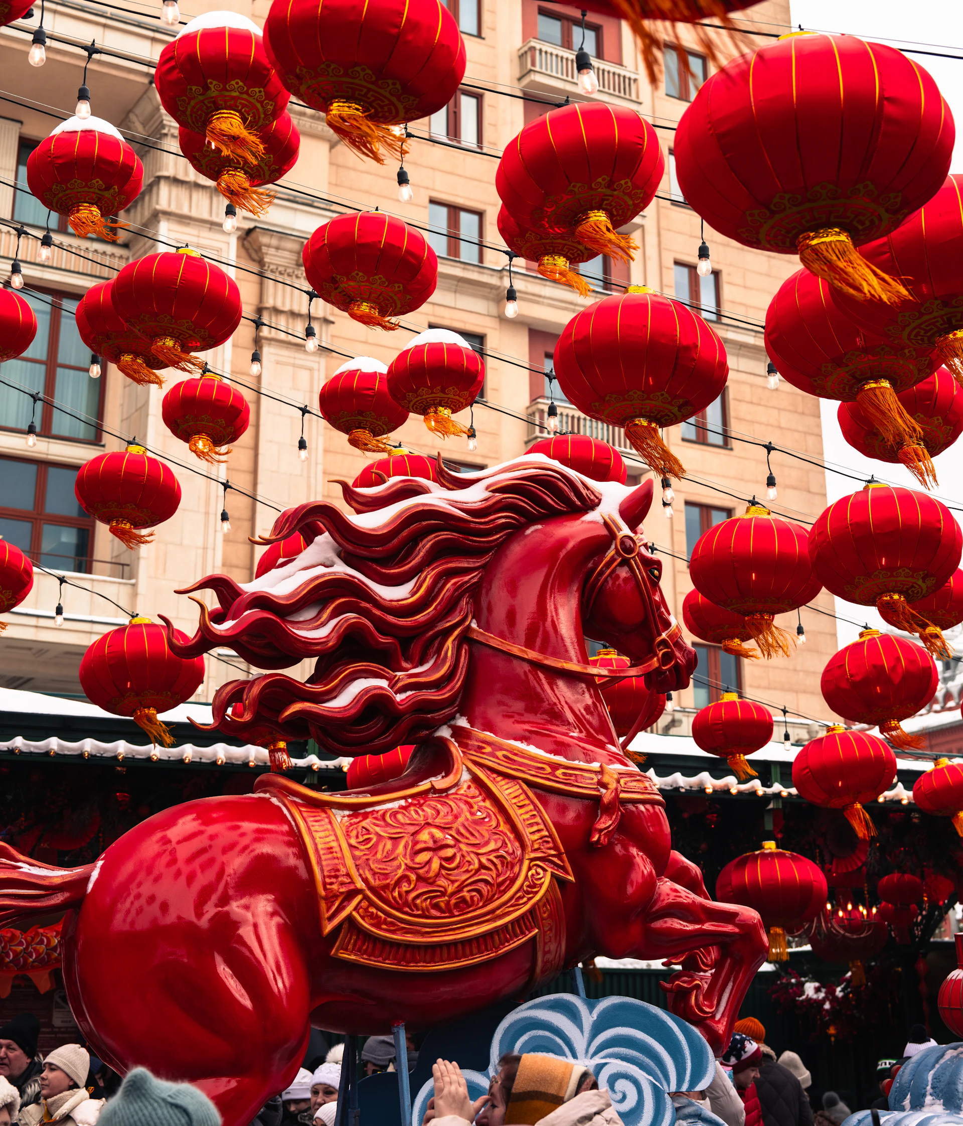 Red horse statue surrounded by hanging chinese lanterns