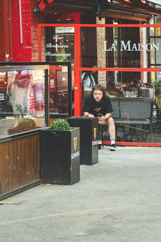 A traveler checking a smartphone at an outdoor café table