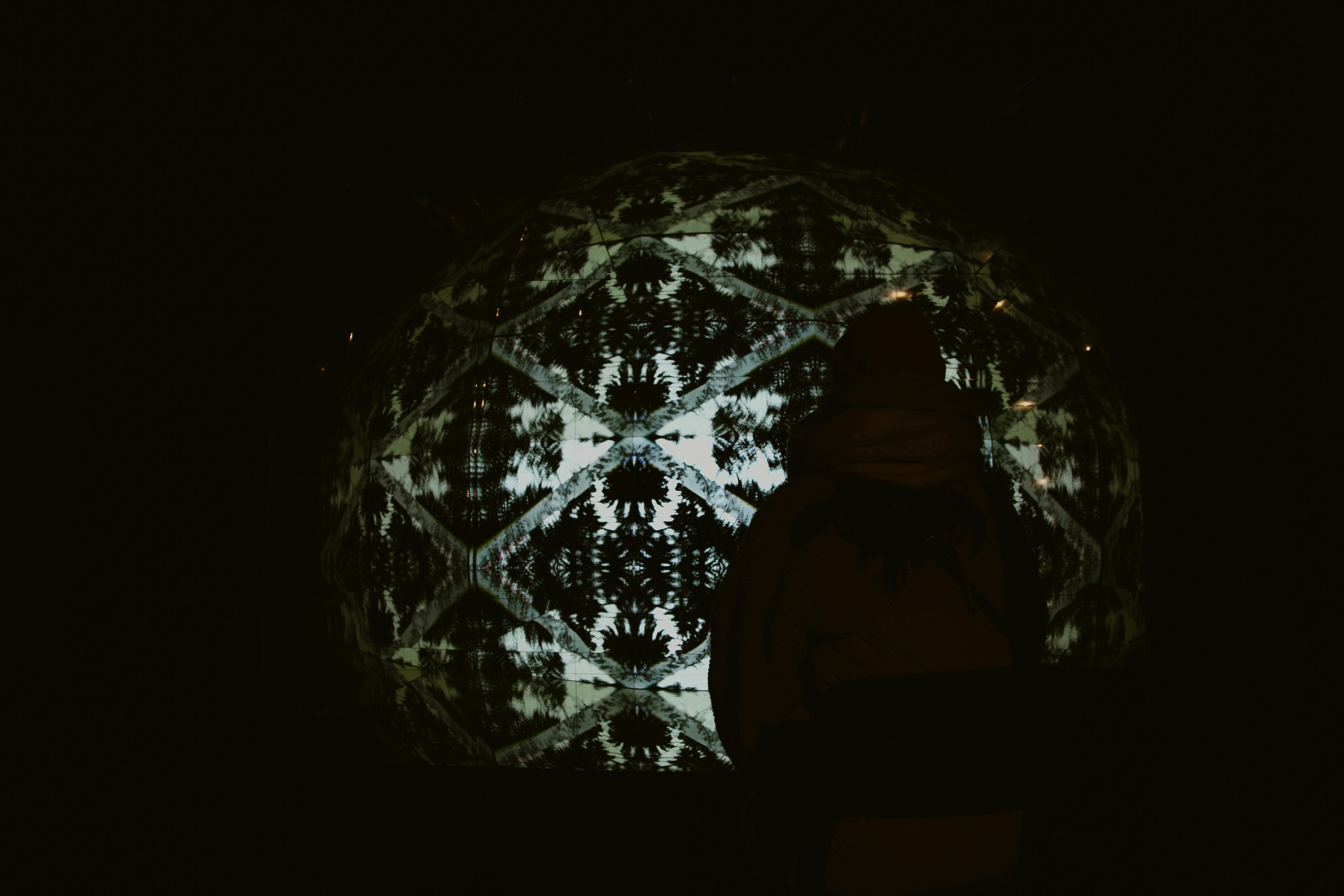 Abstract geometric pattern projected onto a dark surface.