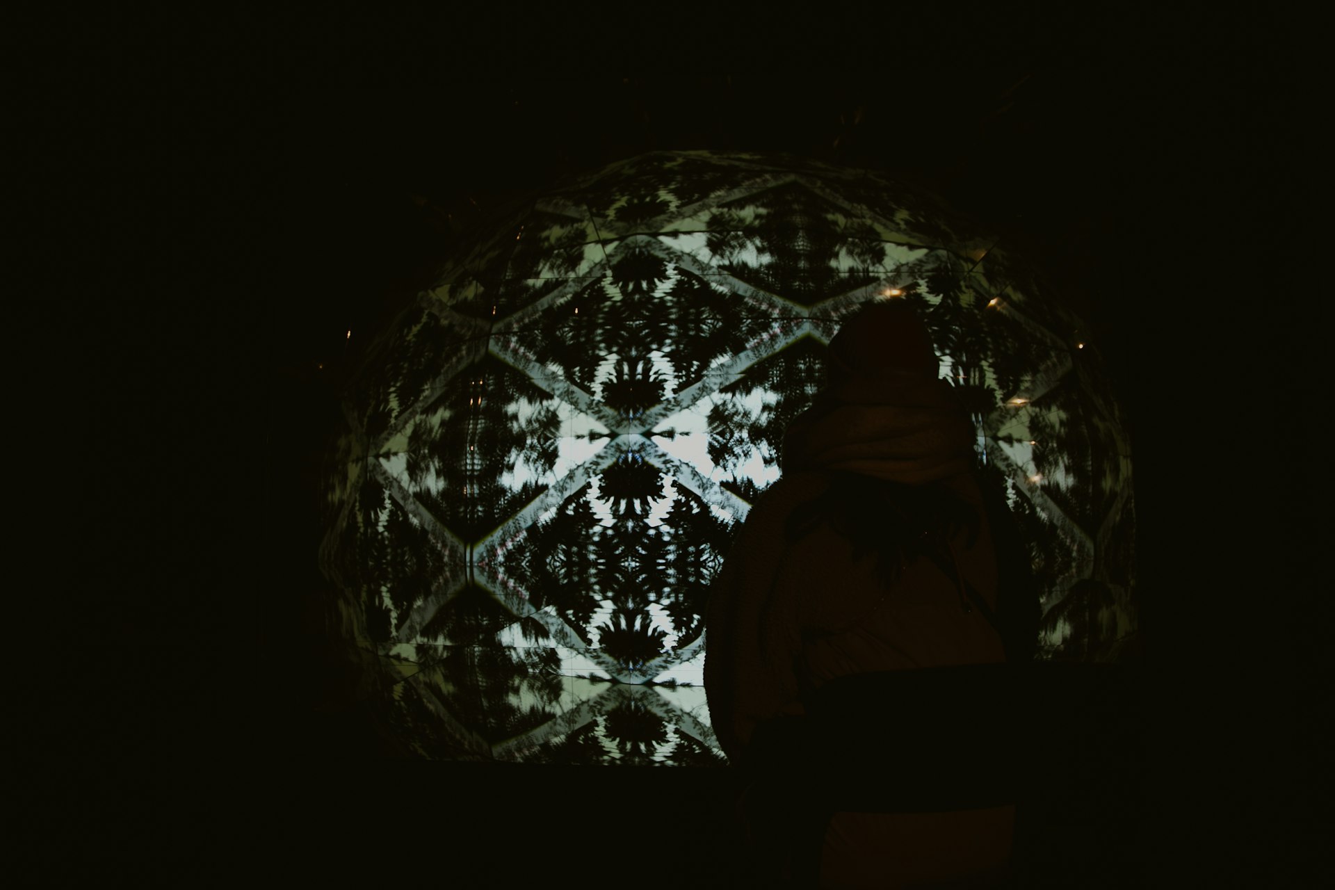 Abstract geometric pattern projected onto a dark surface.