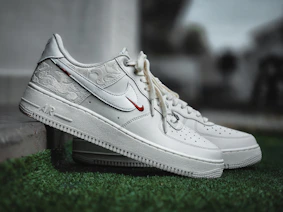 White nike air force 1 sneakers with red accents