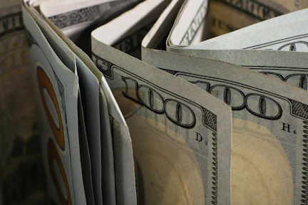 Close-up of folded hundred dollar bills.