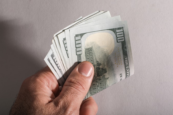 Filmmaker and distributor negotiating a film deal over a contract and financial documents