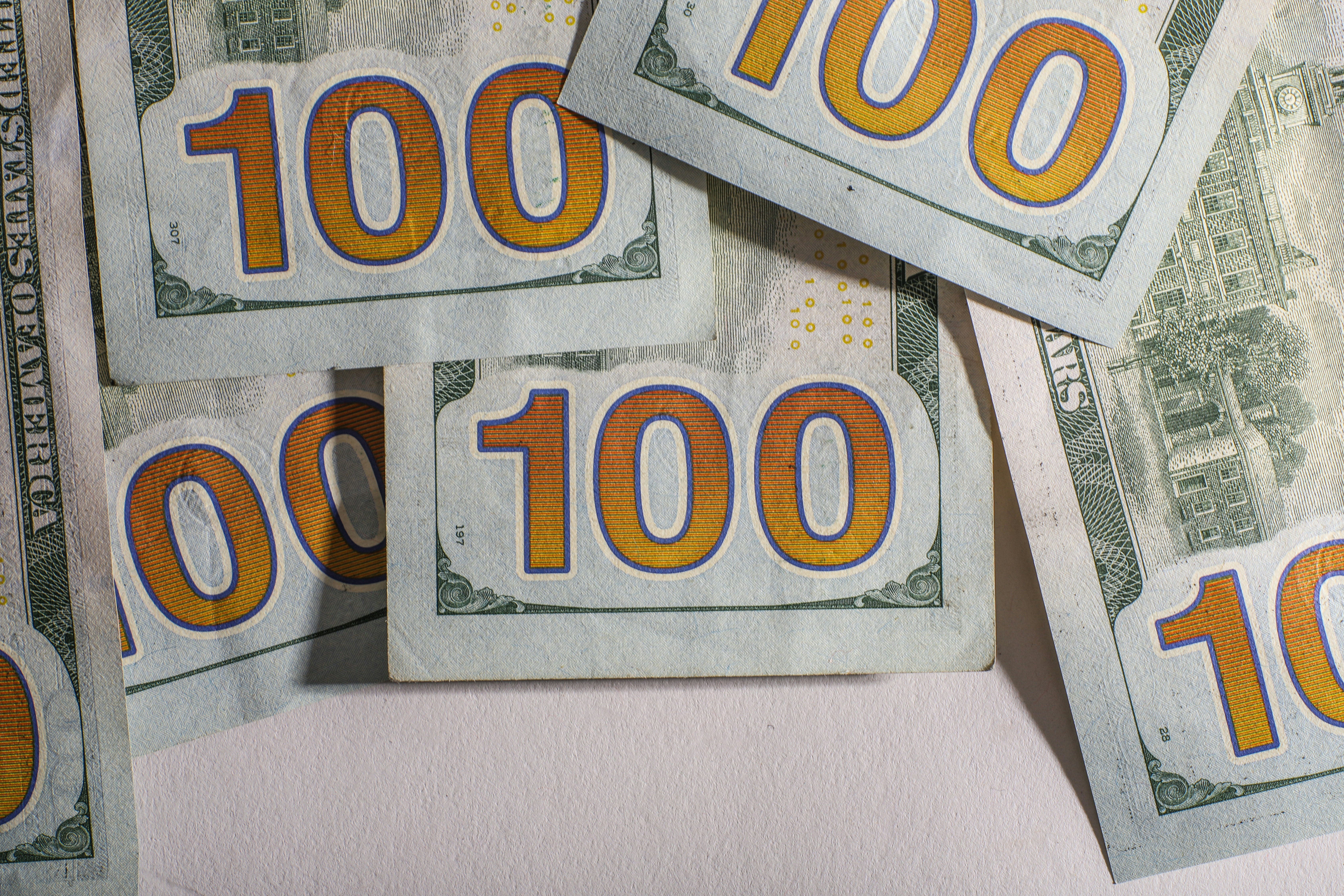 Several us hundred dollar bills are scattered.