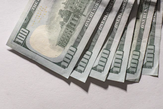 Several us hundred dollar bills fanned out