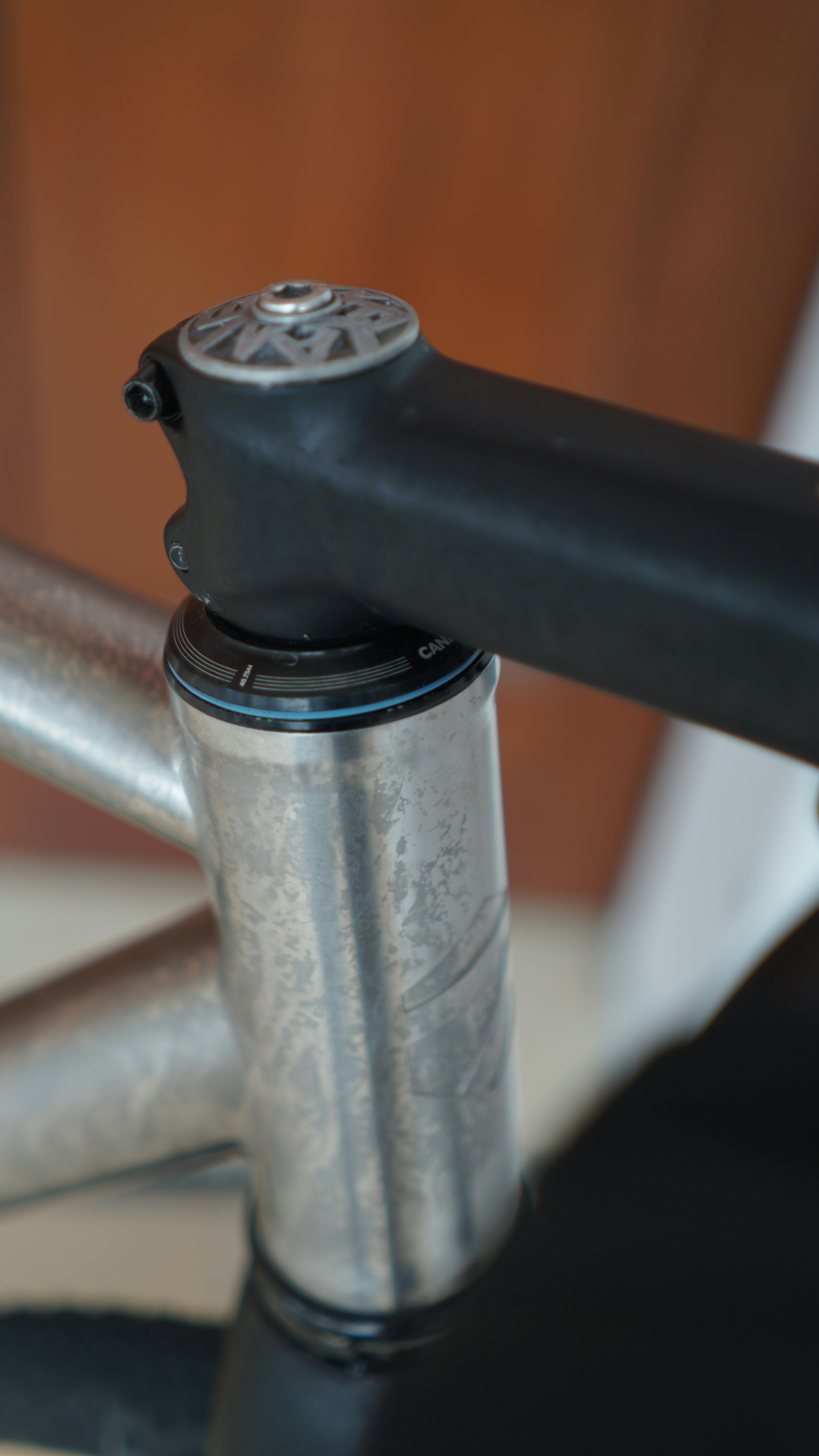 Close-up of a silver bicycle stem and handlebars.