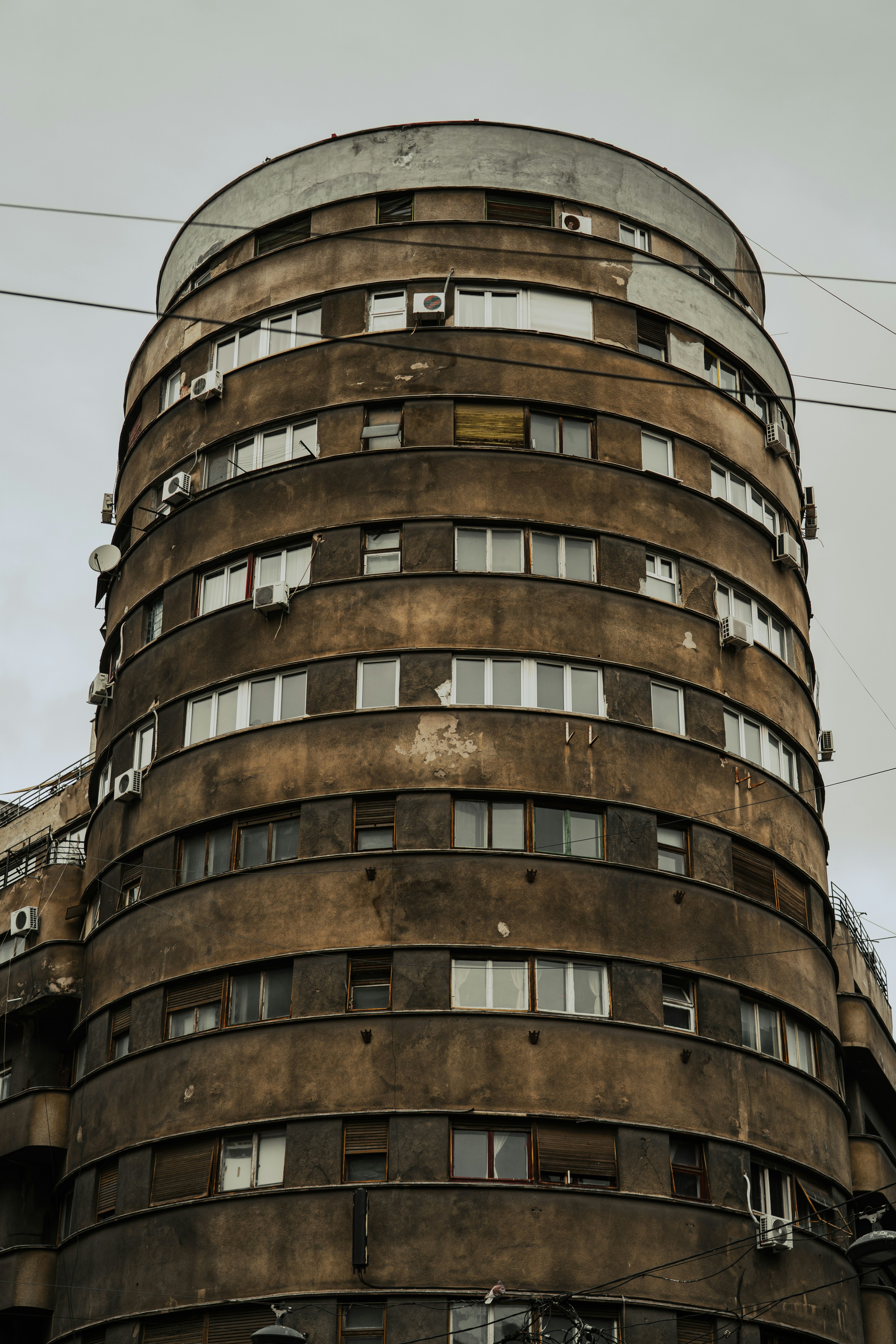 Curved brutalist building with many windows