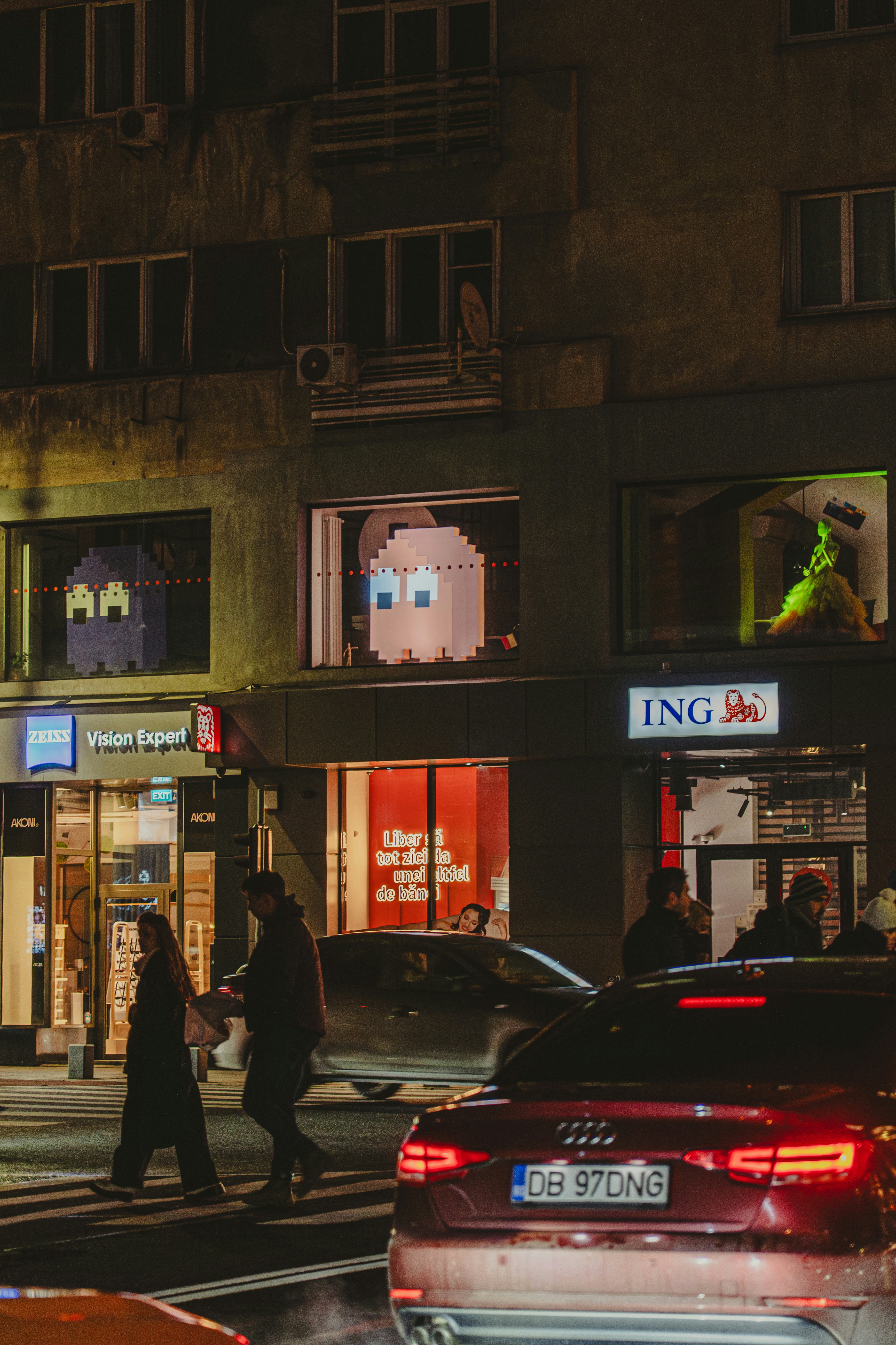 Pac-Man ghosts displayed in apartment windows creating nostalgic retro gaming atmosphere