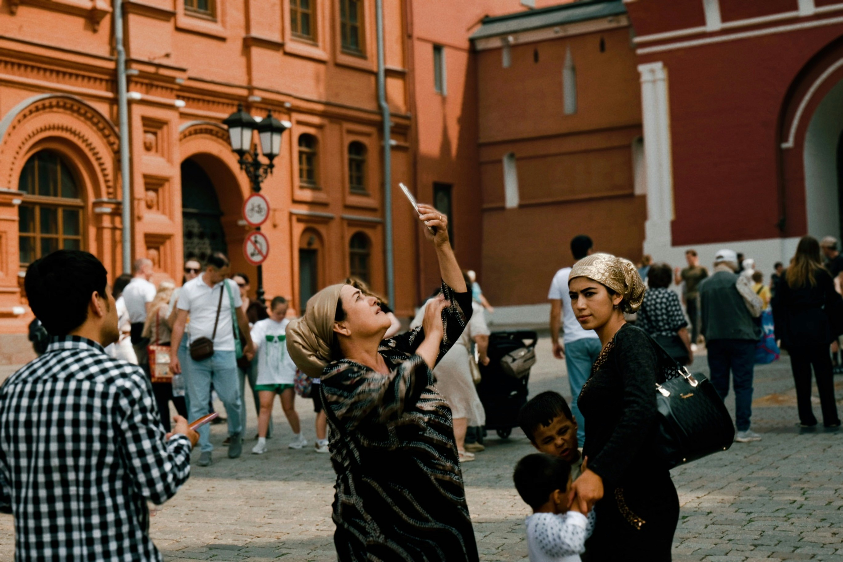 people looking up at buildings in the Moscow city square