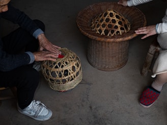 People working with woven bamboo baskets