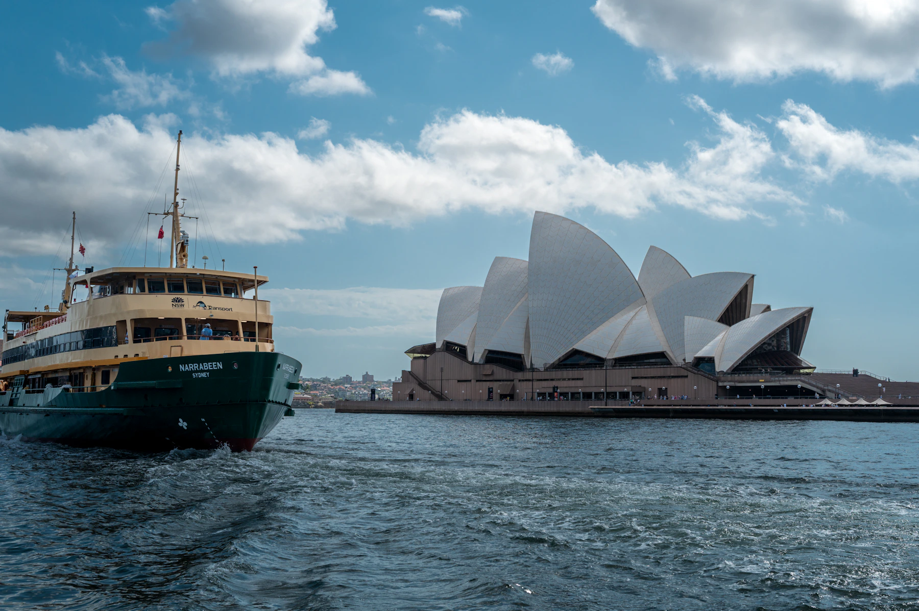 Sydney ferry carrying passengers past the full Opera House at the start of a classic Australia journey