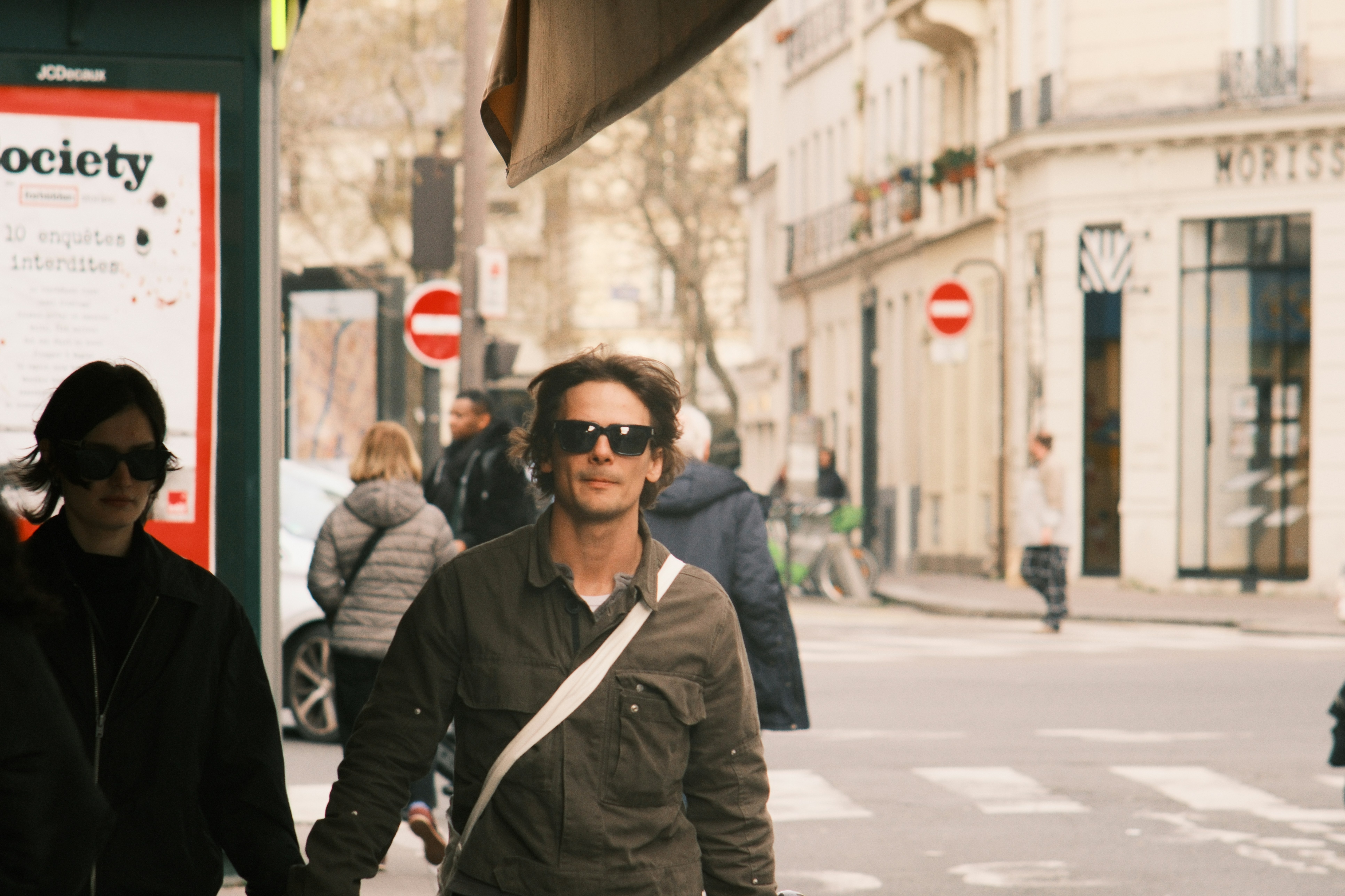 People walking on a city street with buildings