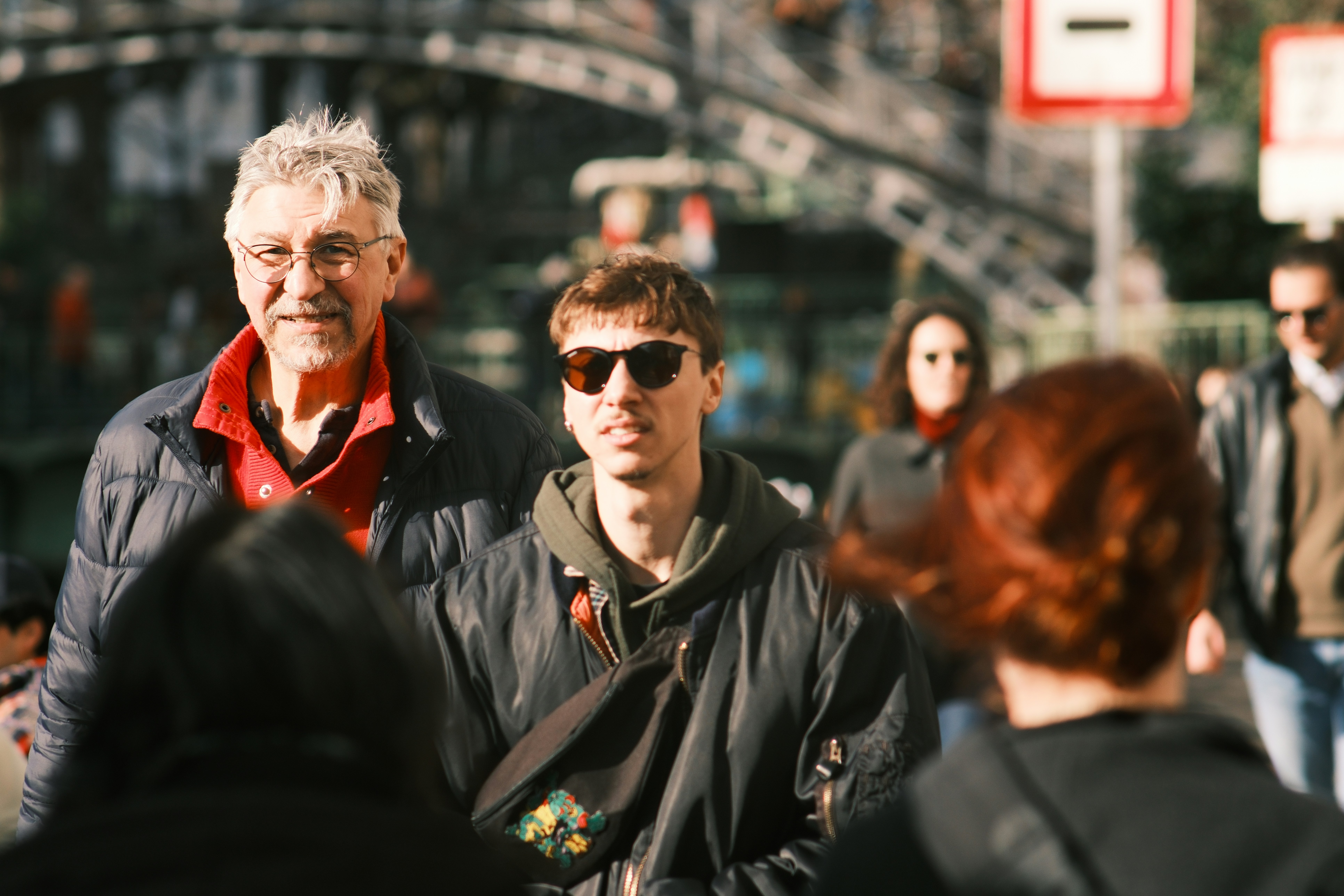 People walking on a sunny city street.