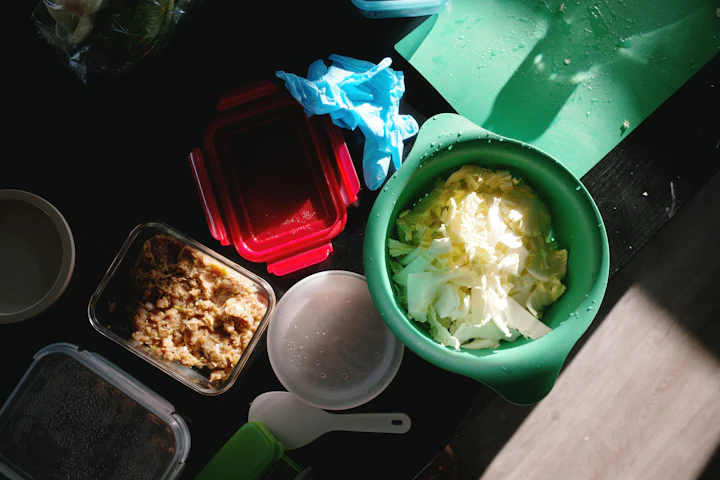 Illustrative scene: Chopped vegetables and cooking ingredients on a work surface. Not a photograph of Salad Container.