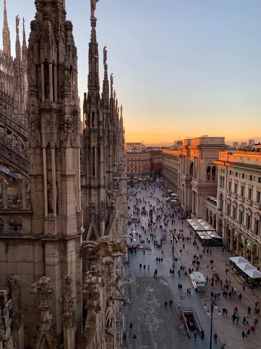 Milan Cathedral rooftop view over Piazza del Duomo at sunset