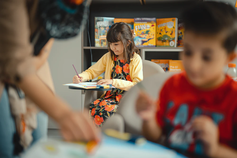 A child working on a craft project with a leader