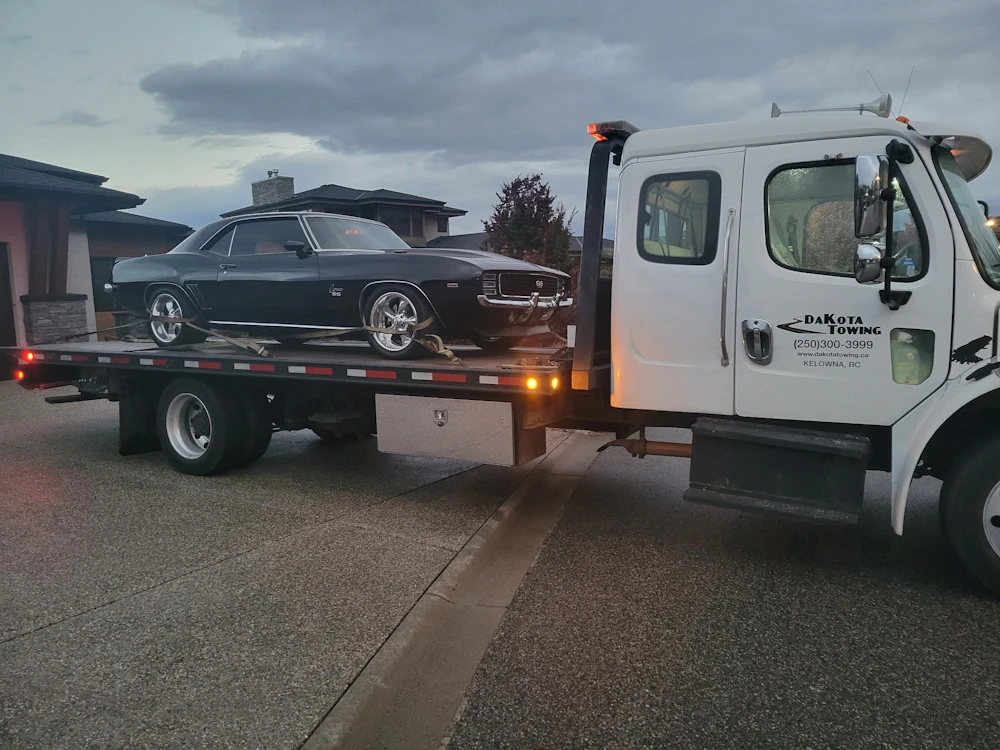 Classic car loaded onto a transport carrier