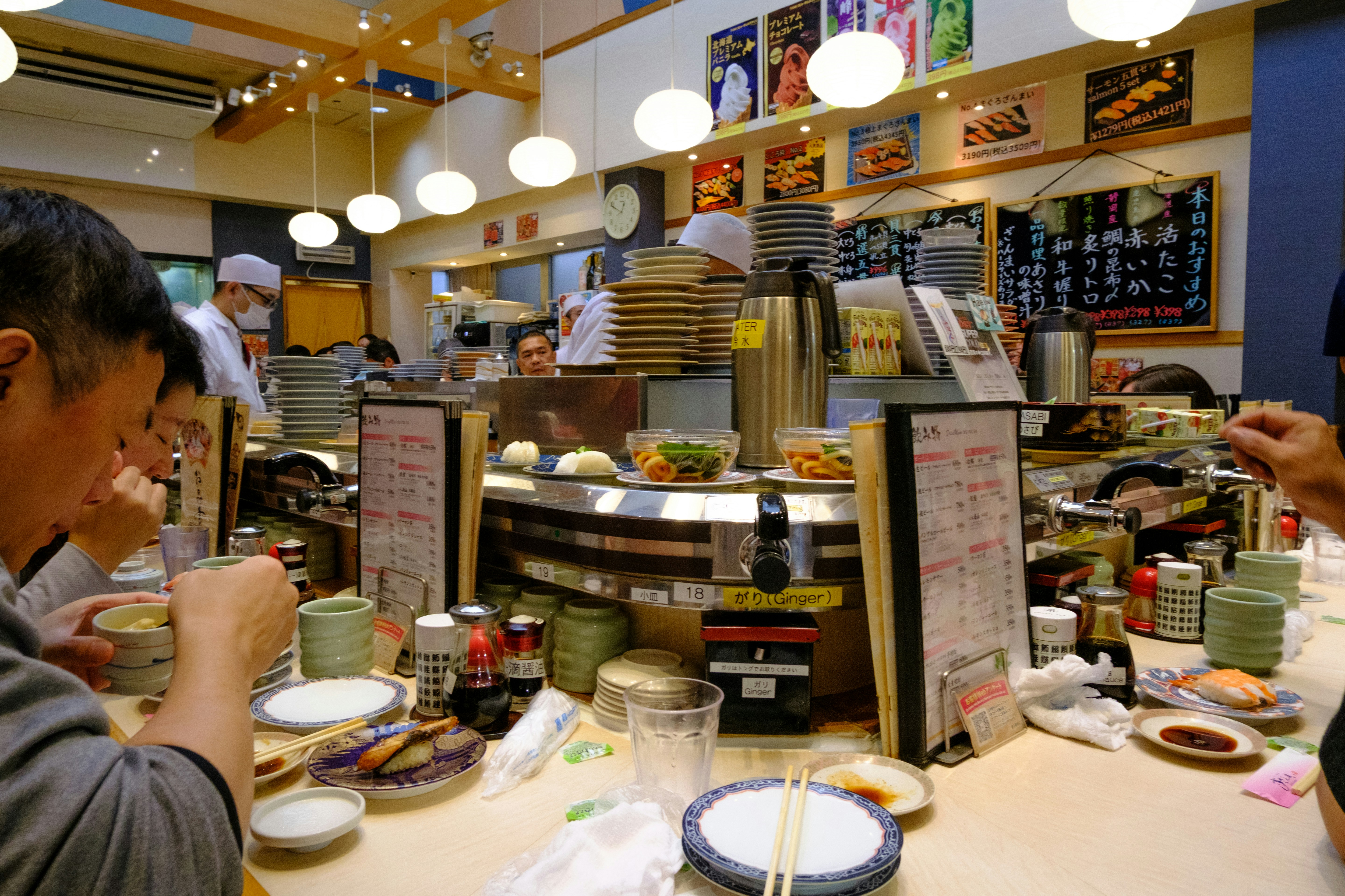 Japanese people eating conveyor belt sushi restaurant