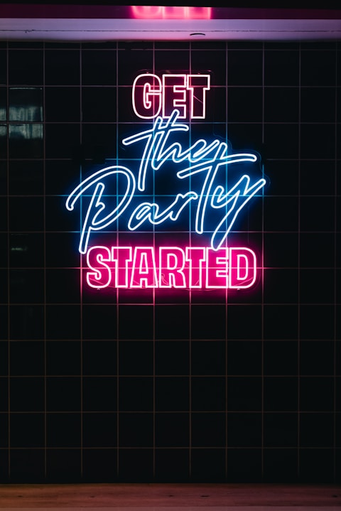 Neon sign says "get the party started"
