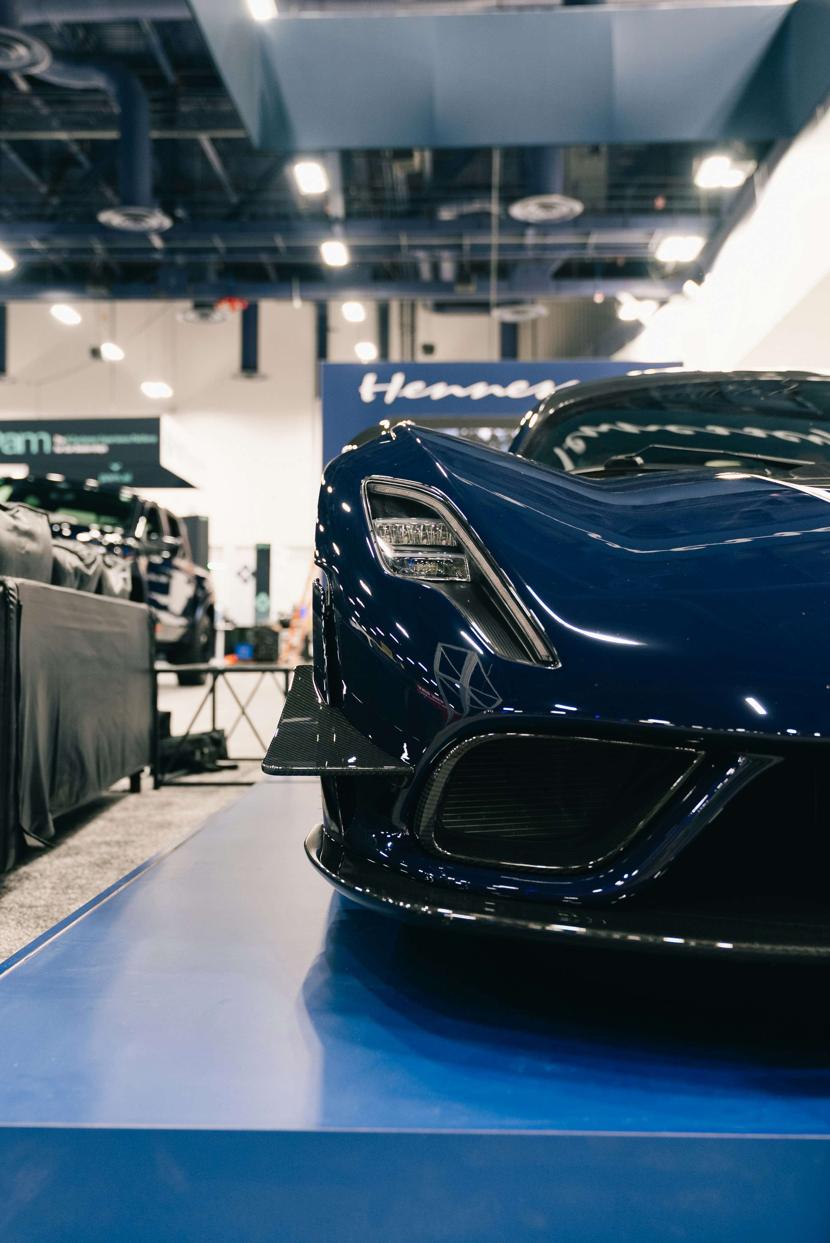 Close-up of a sleek, dark blue sports car.