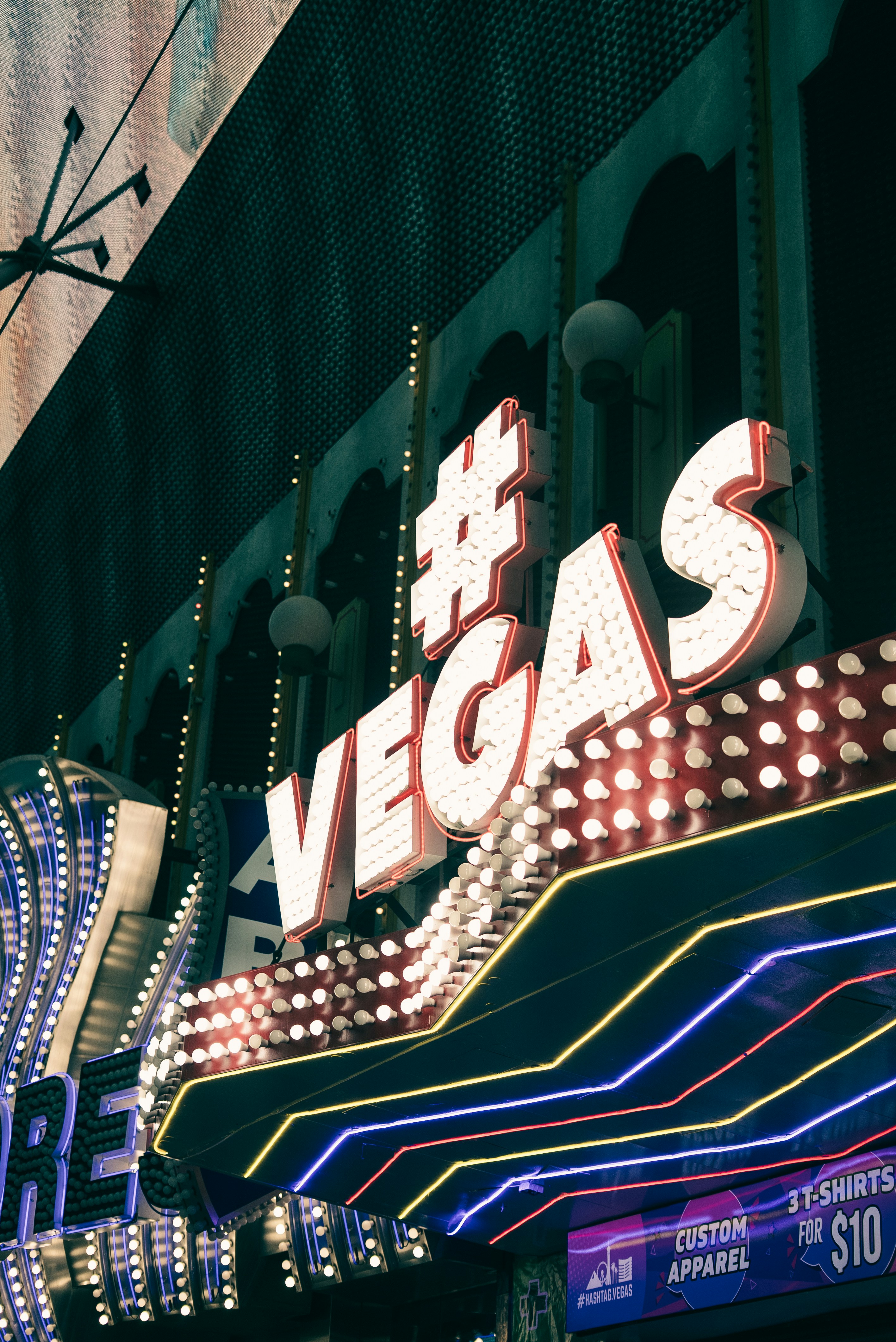 Neon signs light up a building in las vegas.