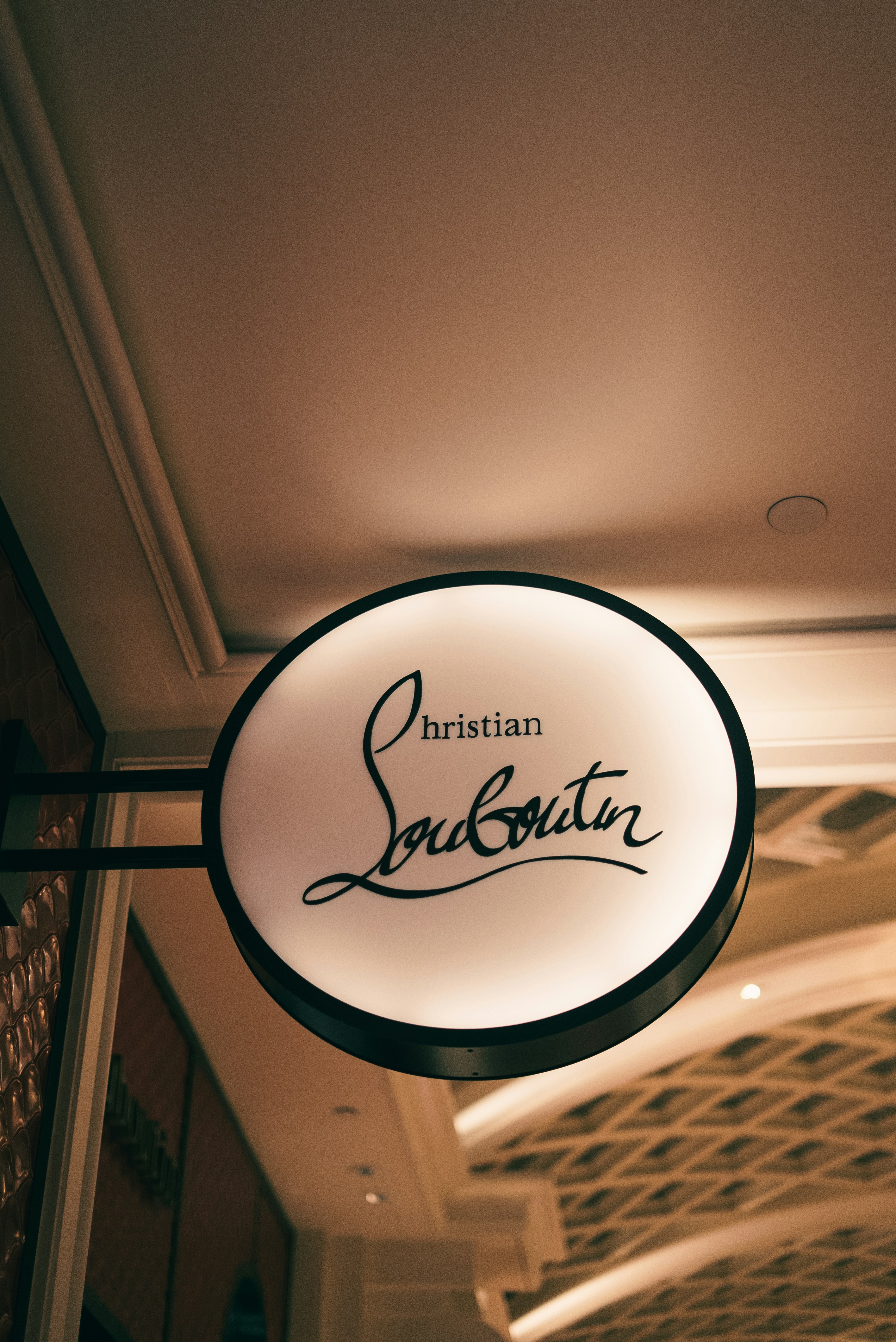 Christian louboutin store sign hanging indoors