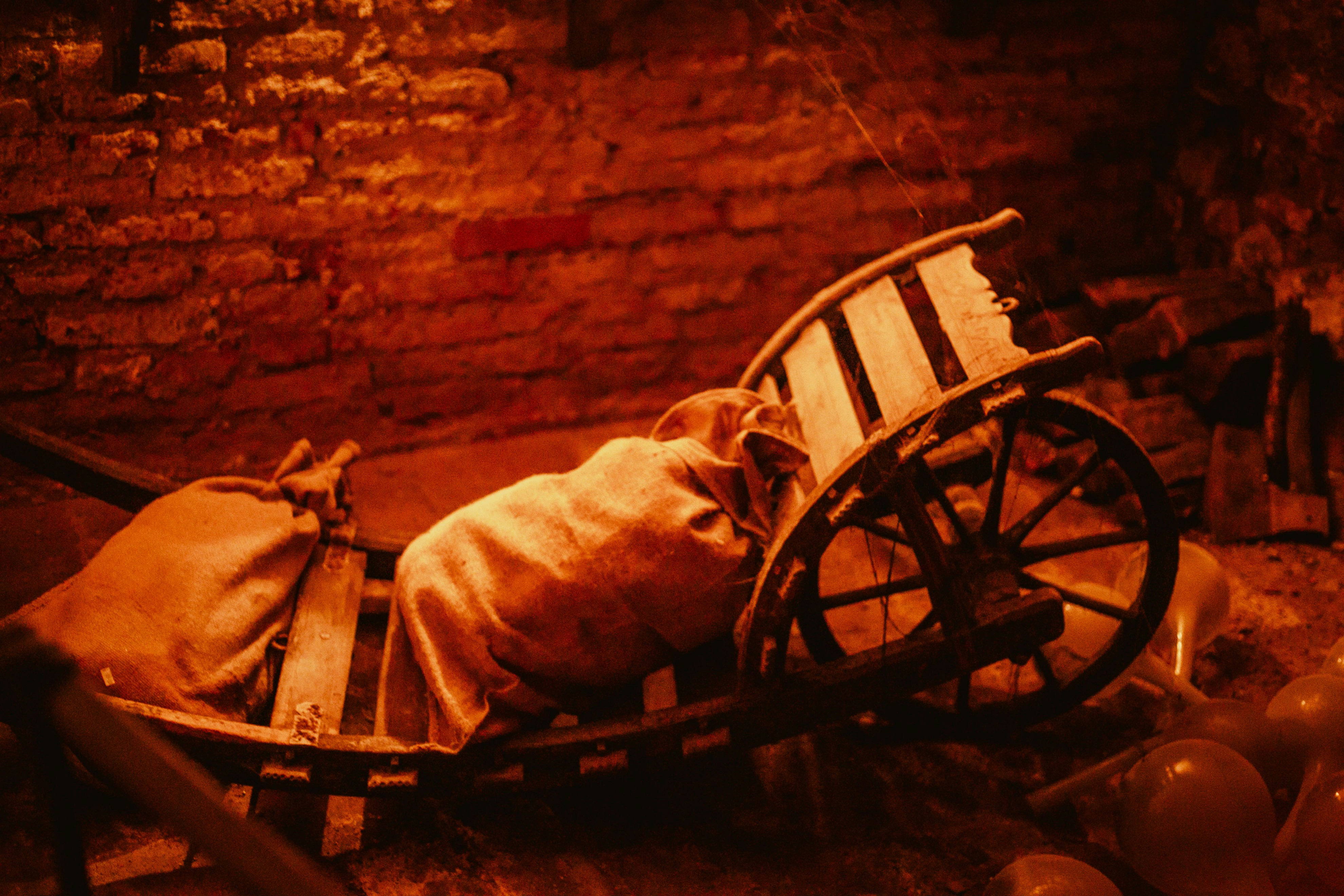 A rustic wooden cart with sacks of goods.