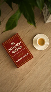 The intelligent investor book with a cup of espresso.