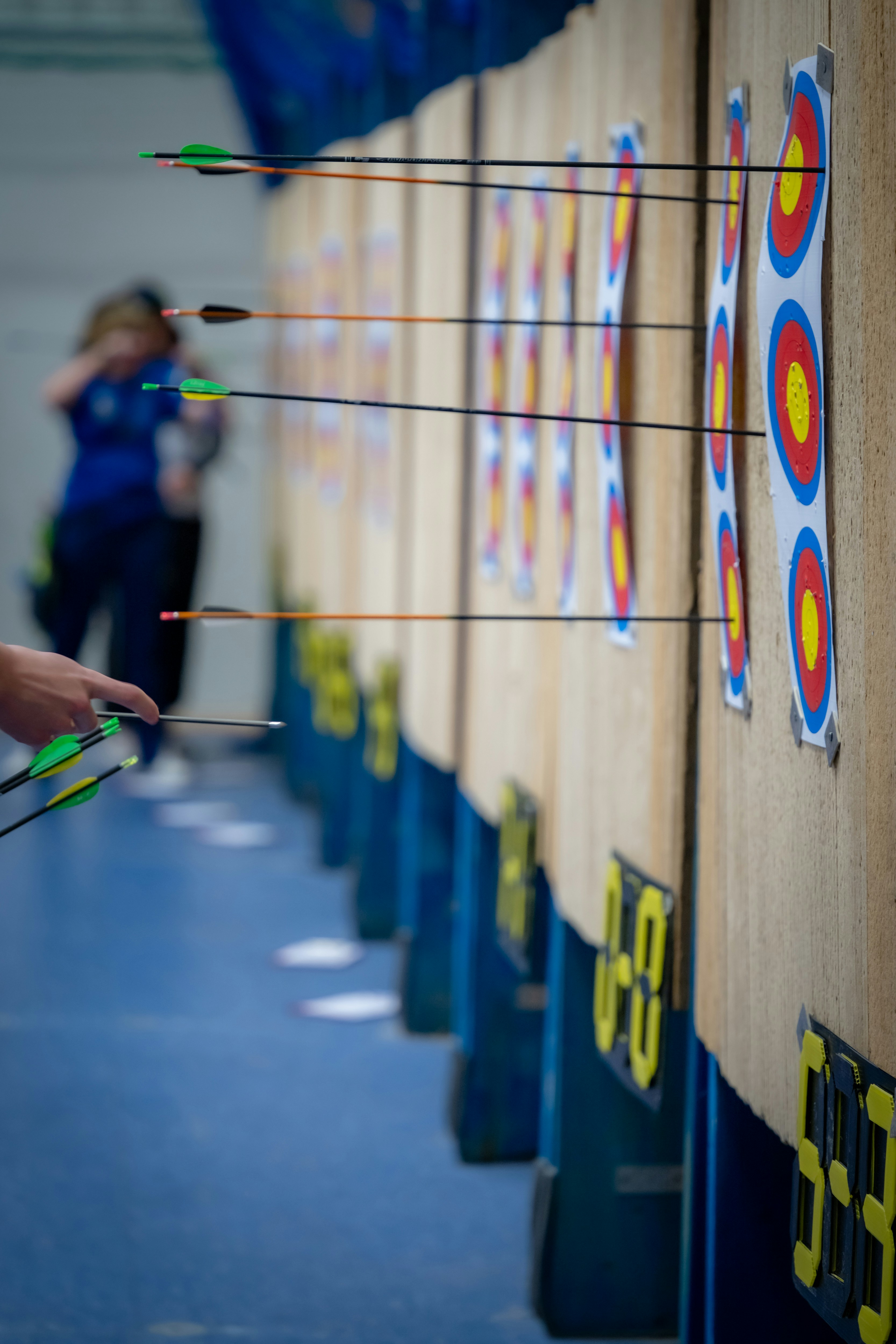 Archery targets with arrows embedded in them at an outdoor practice range