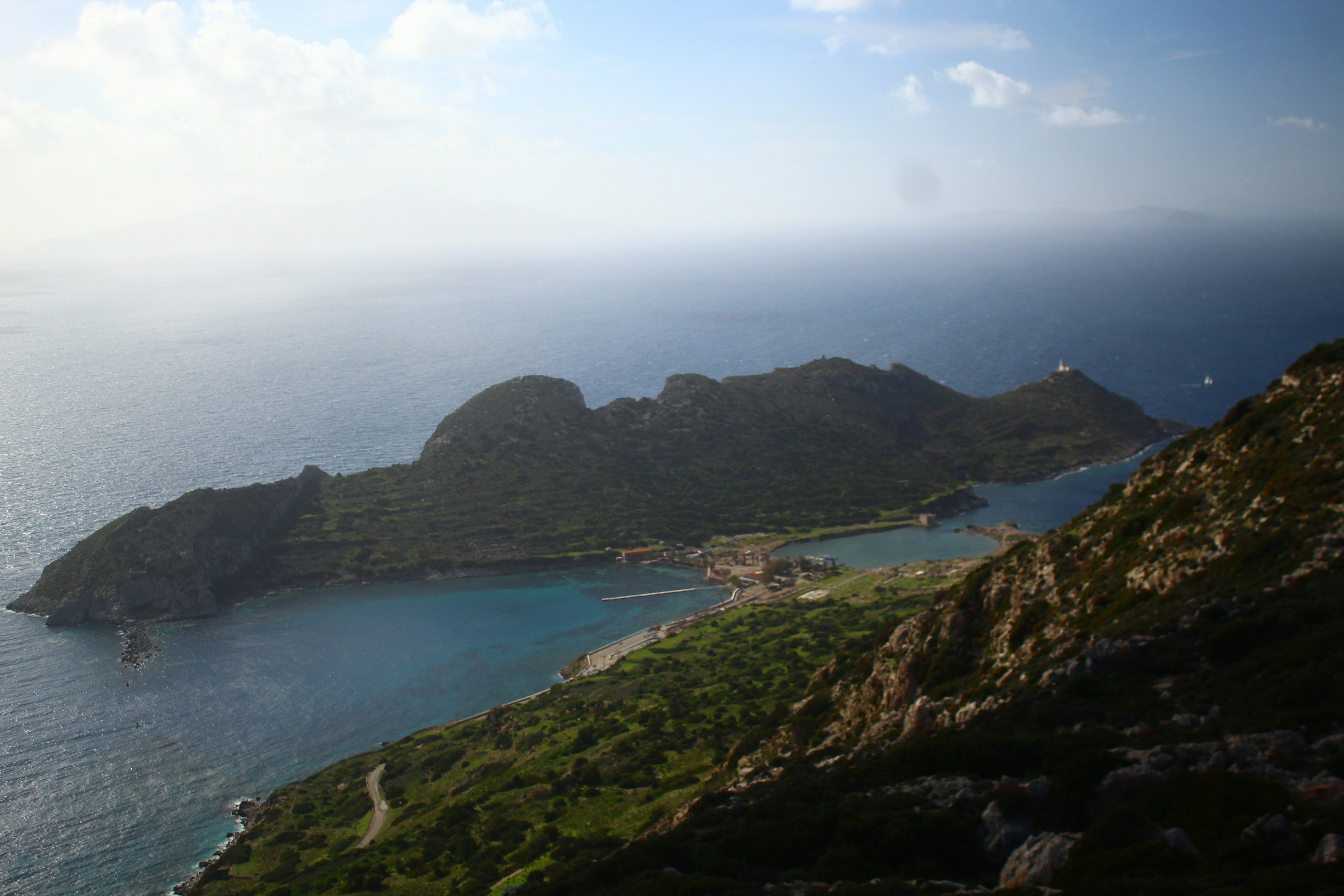 Green island with blue water and buildings