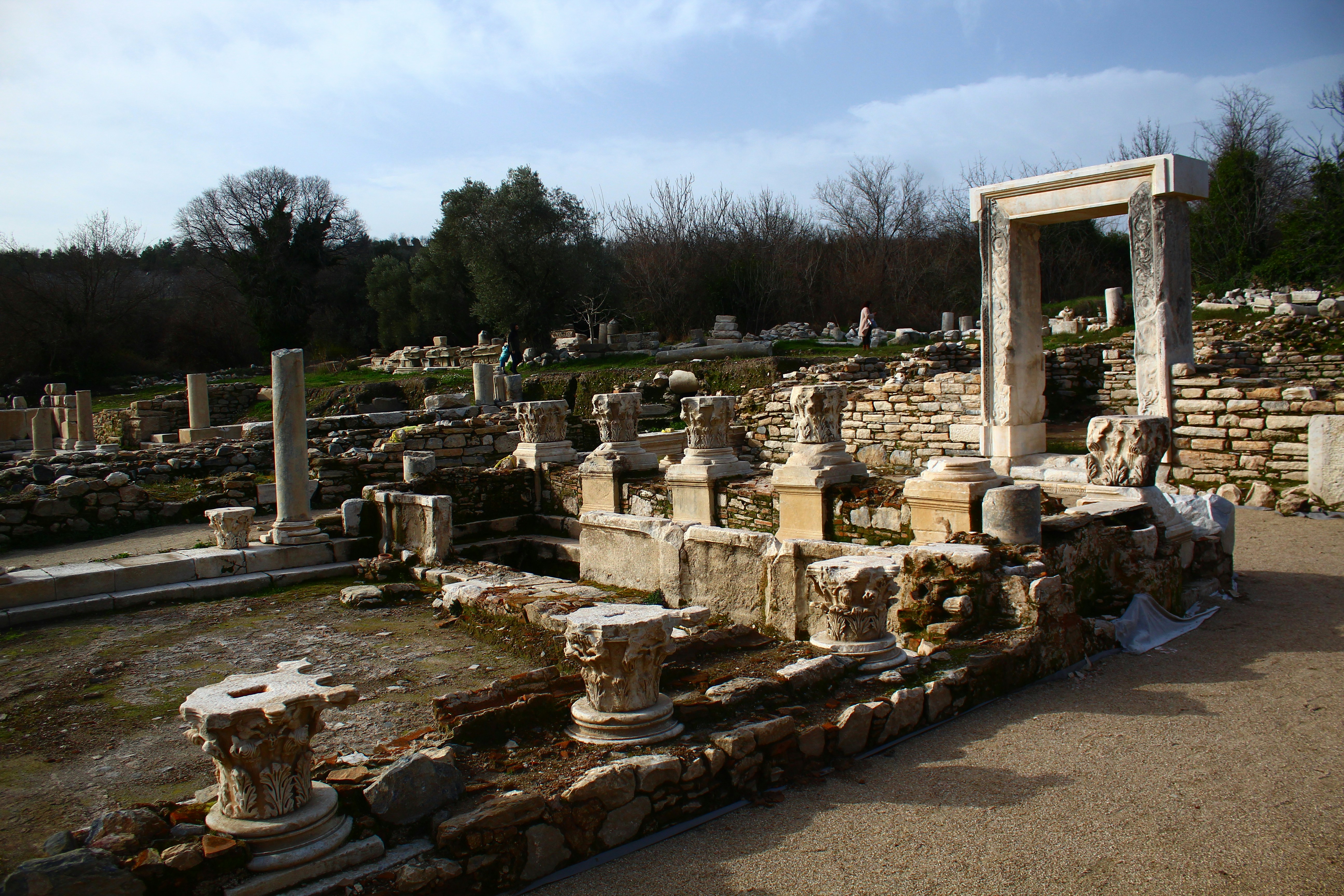 Ancient ruins with stone columns and structures under sky
