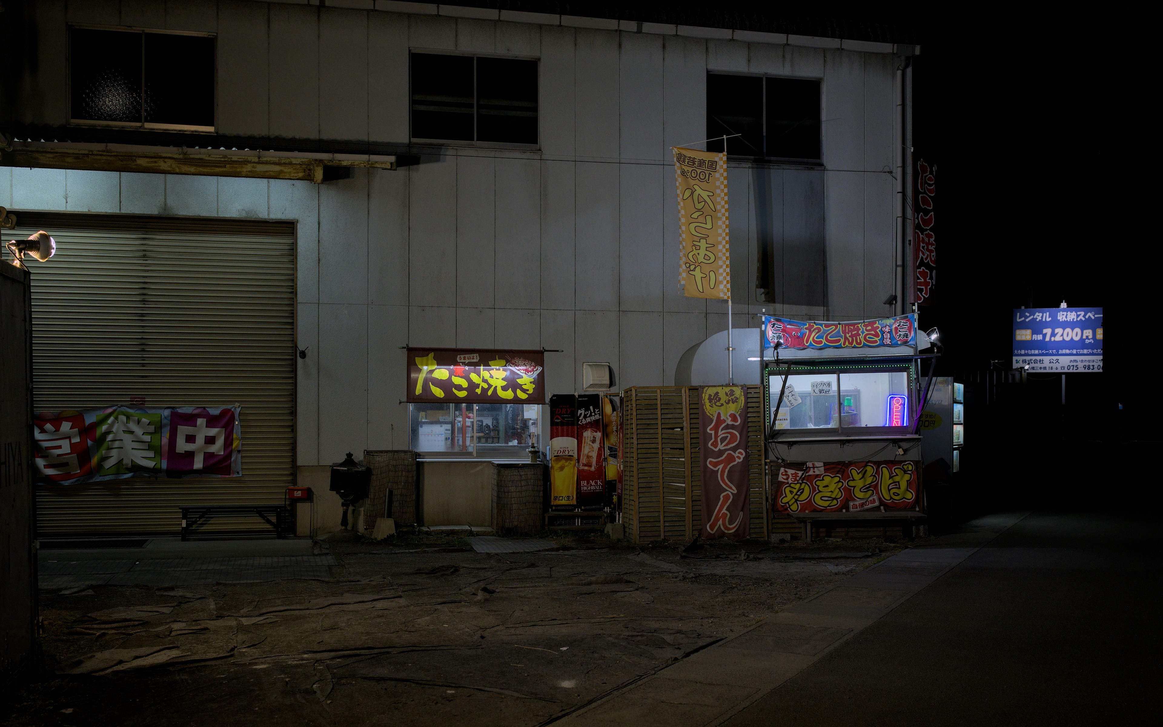 Food stalls illuminated at night outside building