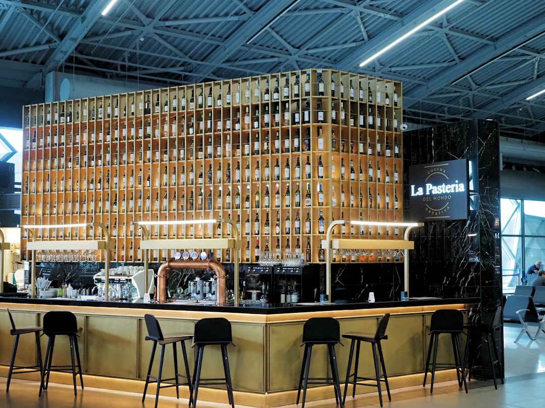 Modern bar with wooden shelves and bottles