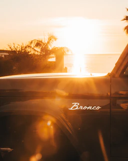Classic bronco truck at sunset with lens flare