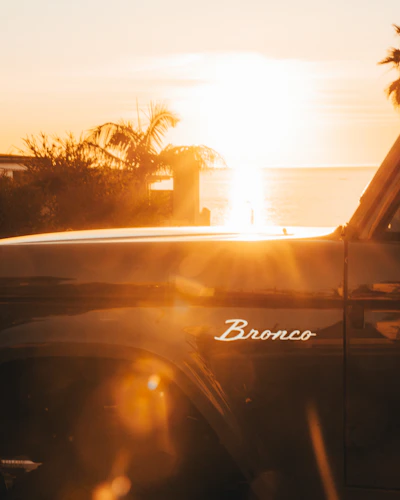 Classic bronco truck at sunset with lens flare