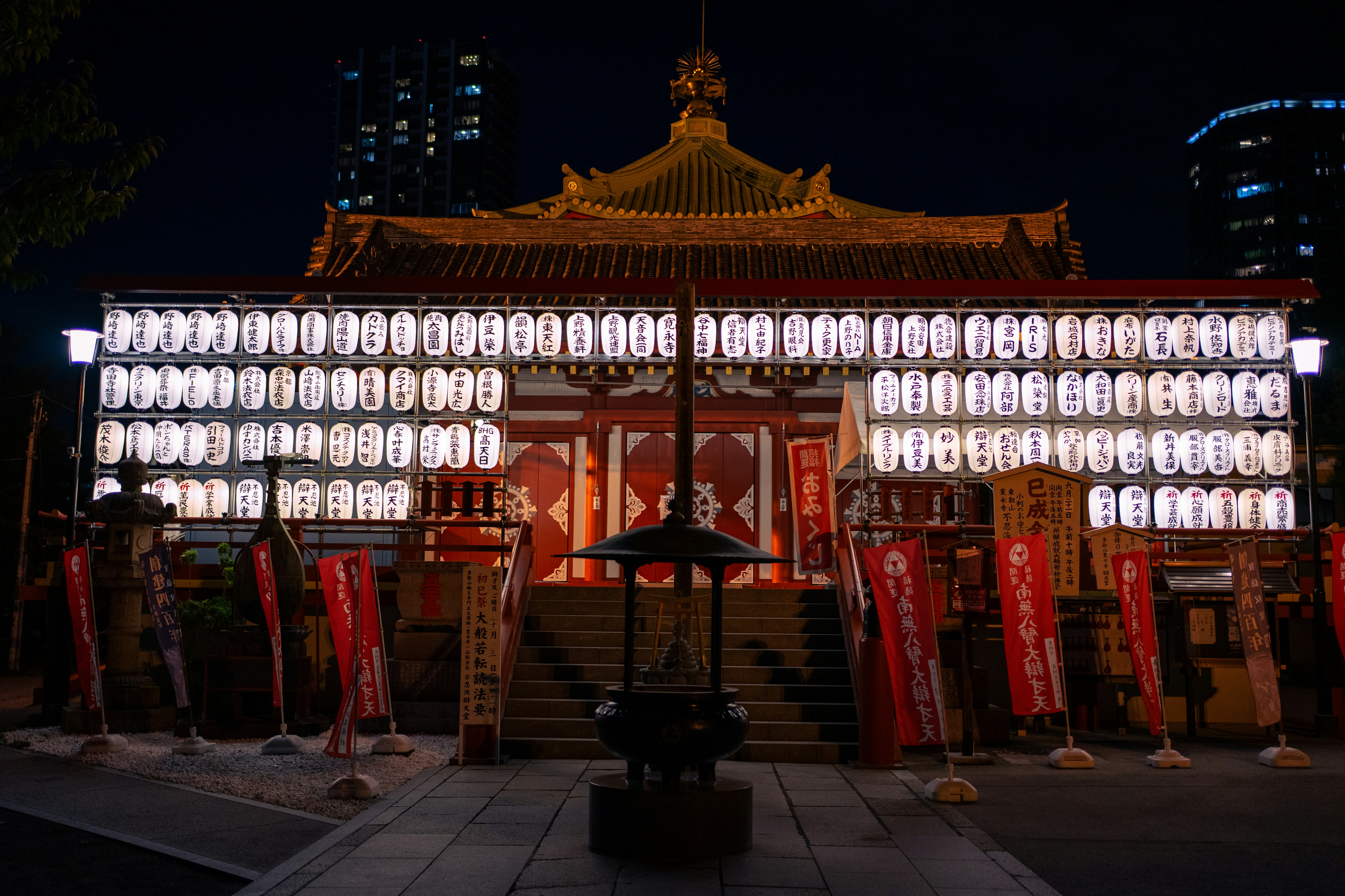 Japanese temple illuminated with lanterns at night