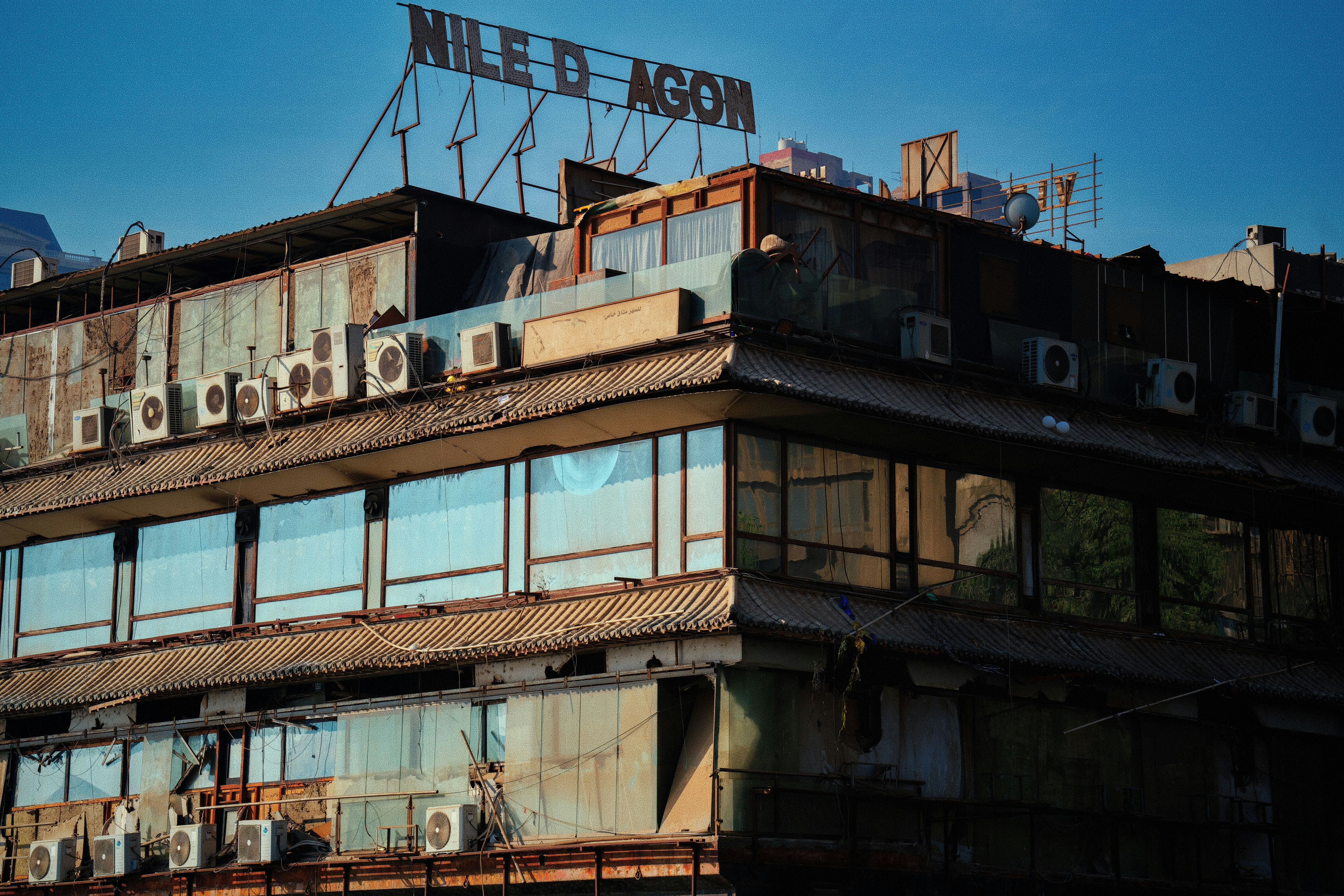 Rusted building with multiple air conditioning units.