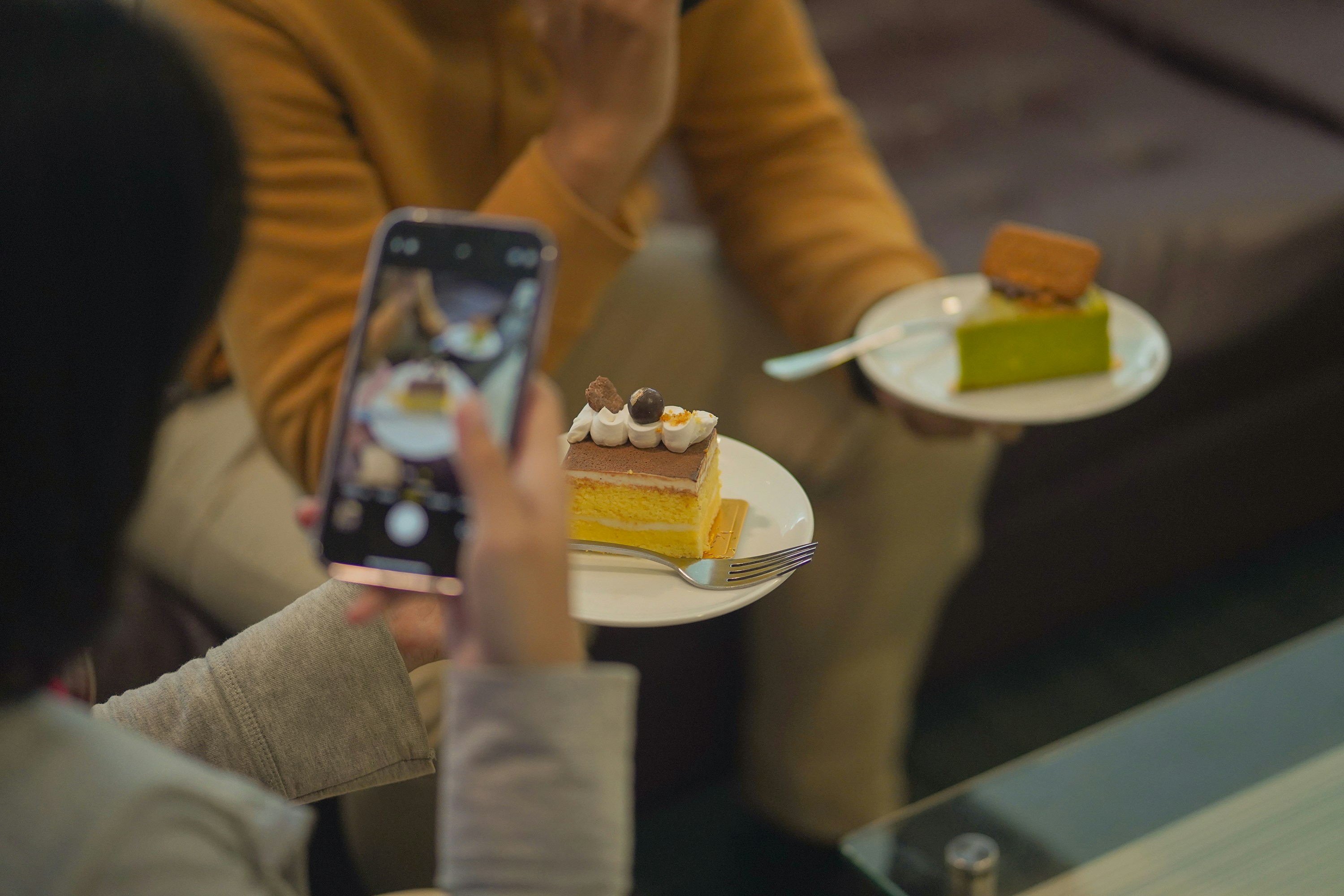 Person taking a picture of a dessert with phone