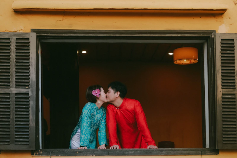 Couple kissing in a window