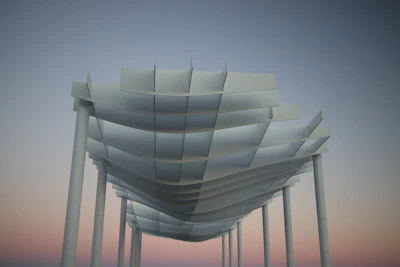 Modern white architectural structure against a soft sky