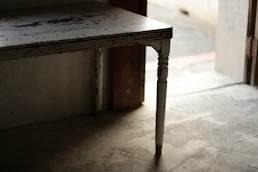An old wooden table with a single leg.