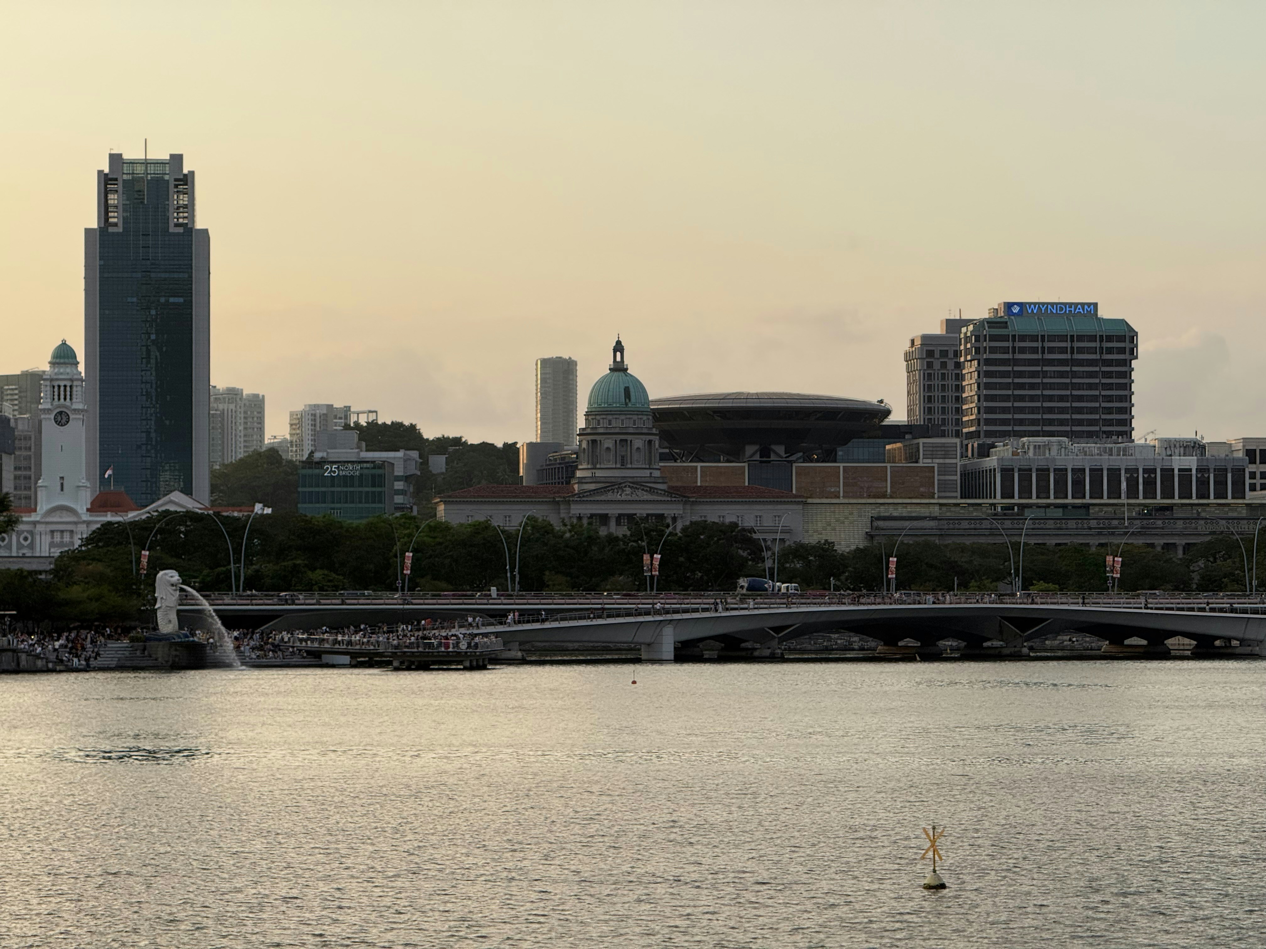 City skyline with waterfront and bridge at dusk