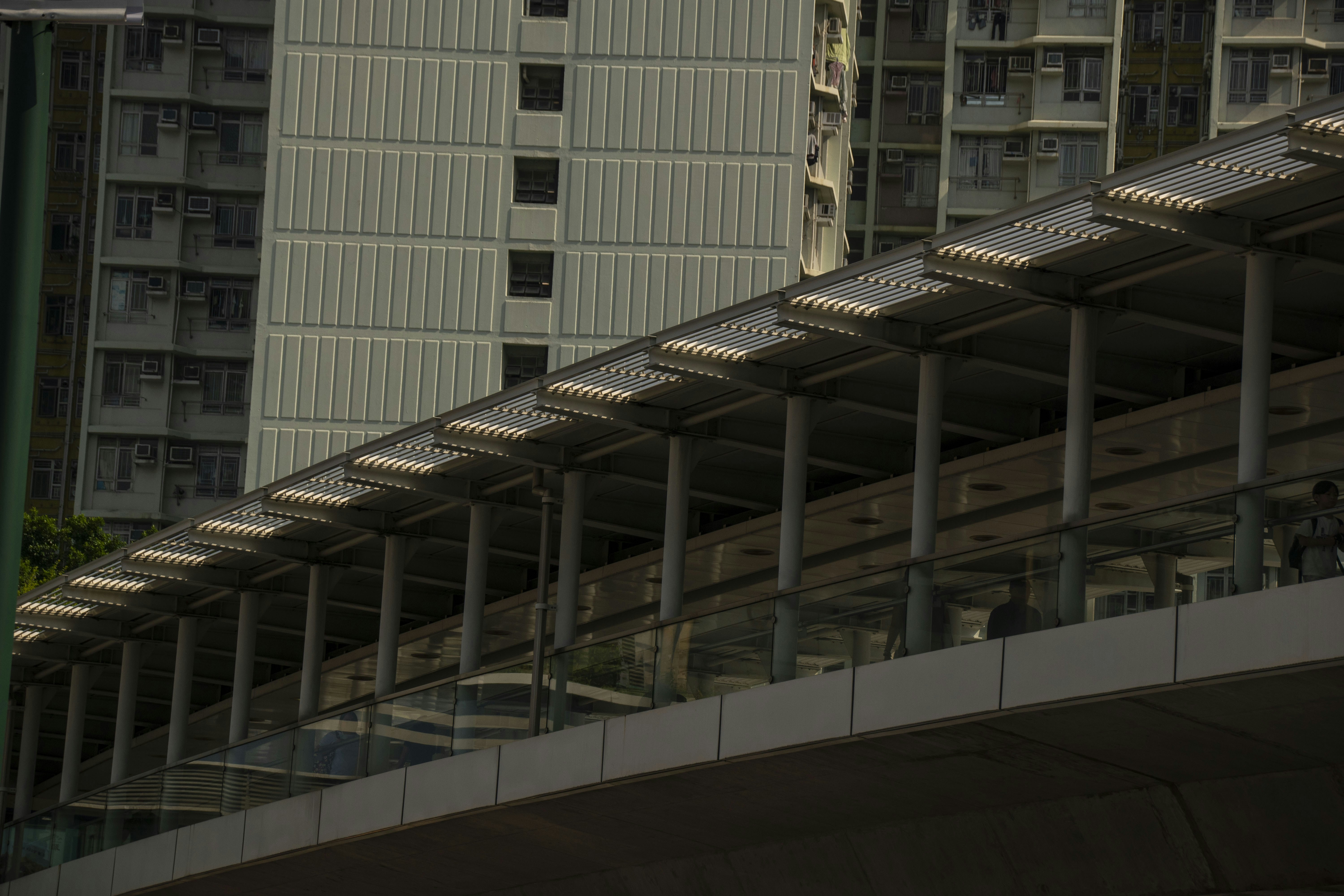Modern elevated walkway with apartment buildings behind