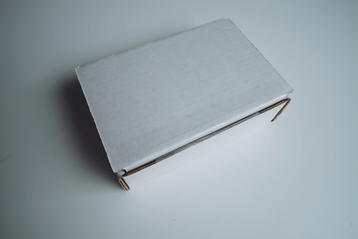 Simple white shipping box on a white surface