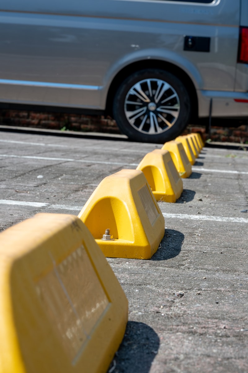 Yellow parking lot bollards and safety markings in a commercial lot