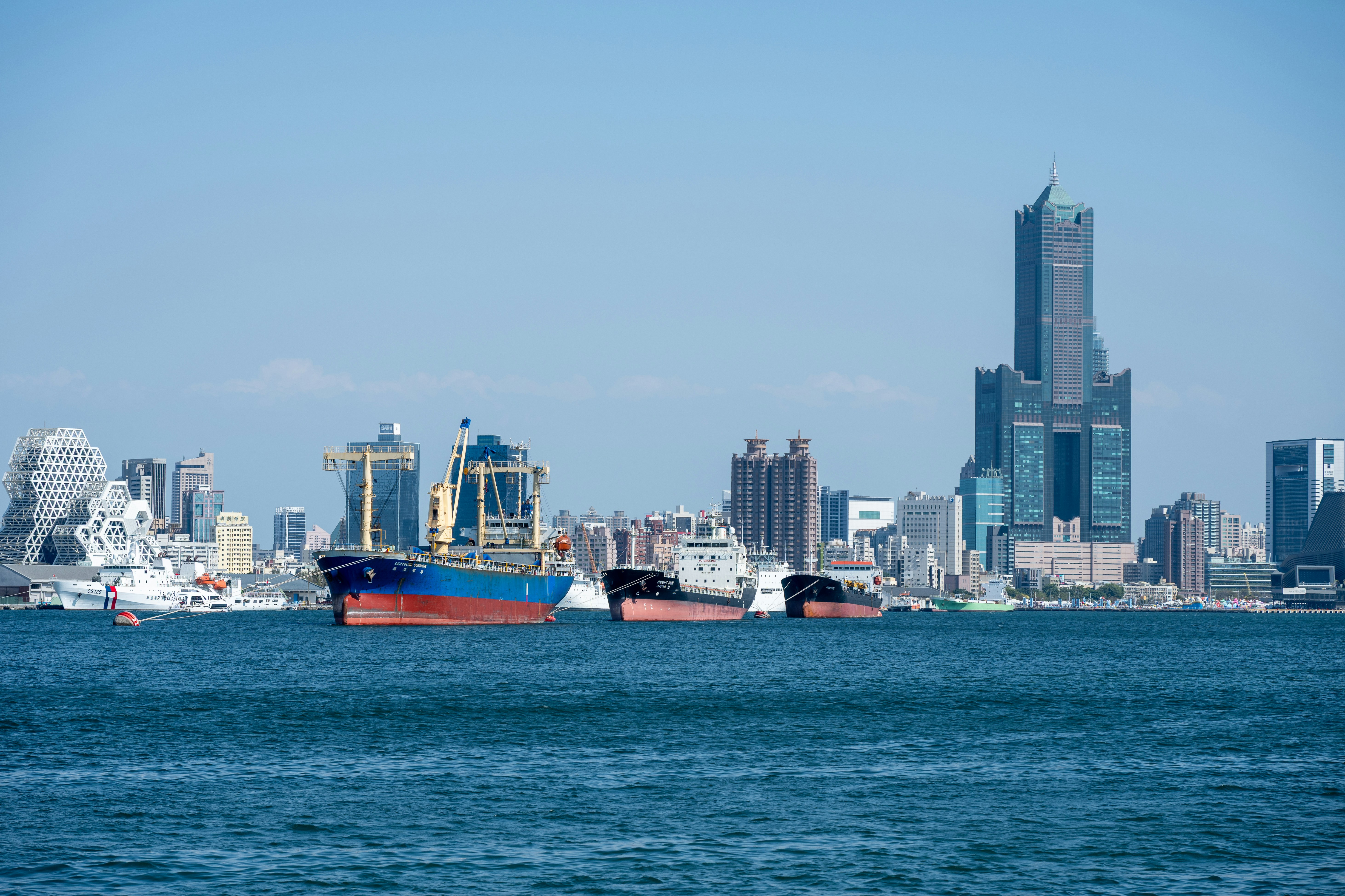 Ships on the water with a city skyline background