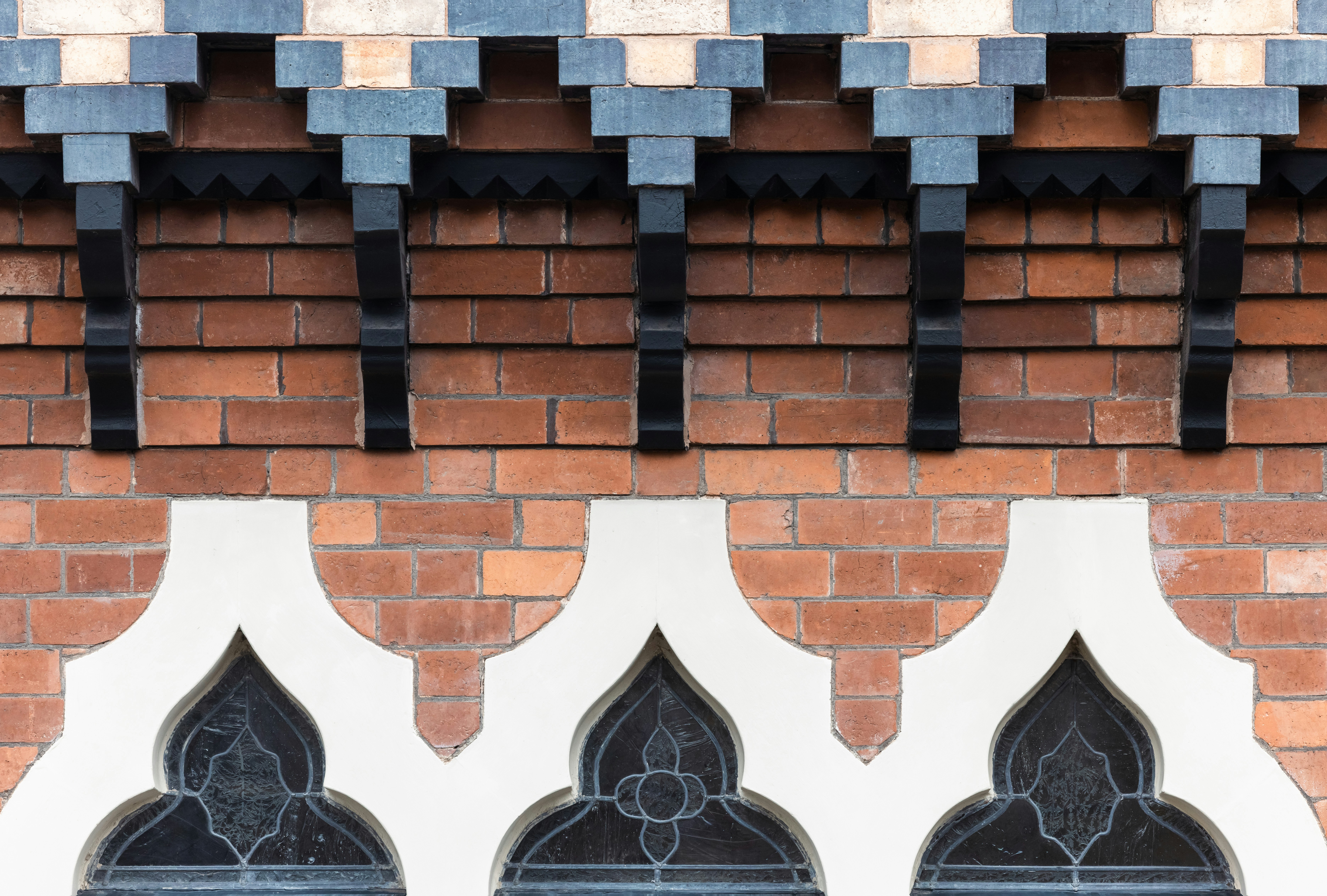 Ornate architectural details with brick and white stucco